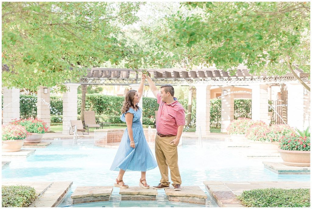 twirling spin dance engaged couple by pool in las colinas
