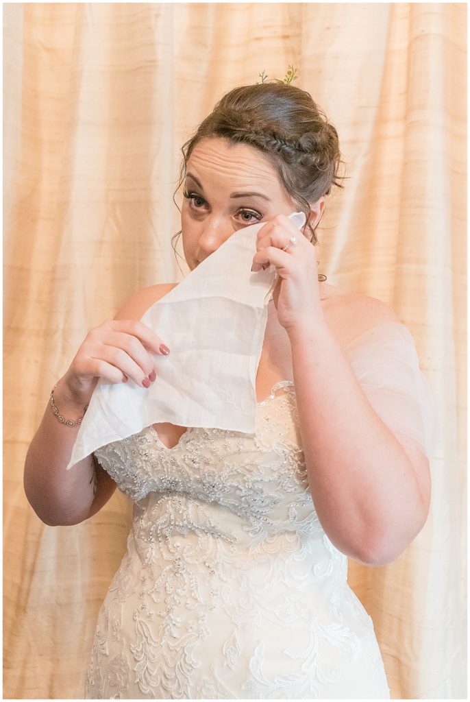 bride drying her tears lace wedding dress sweetheart neckline