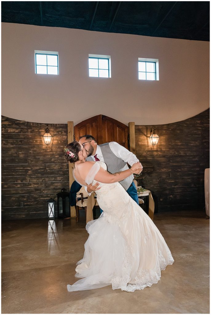 bride and groom dip kiss during first dance
