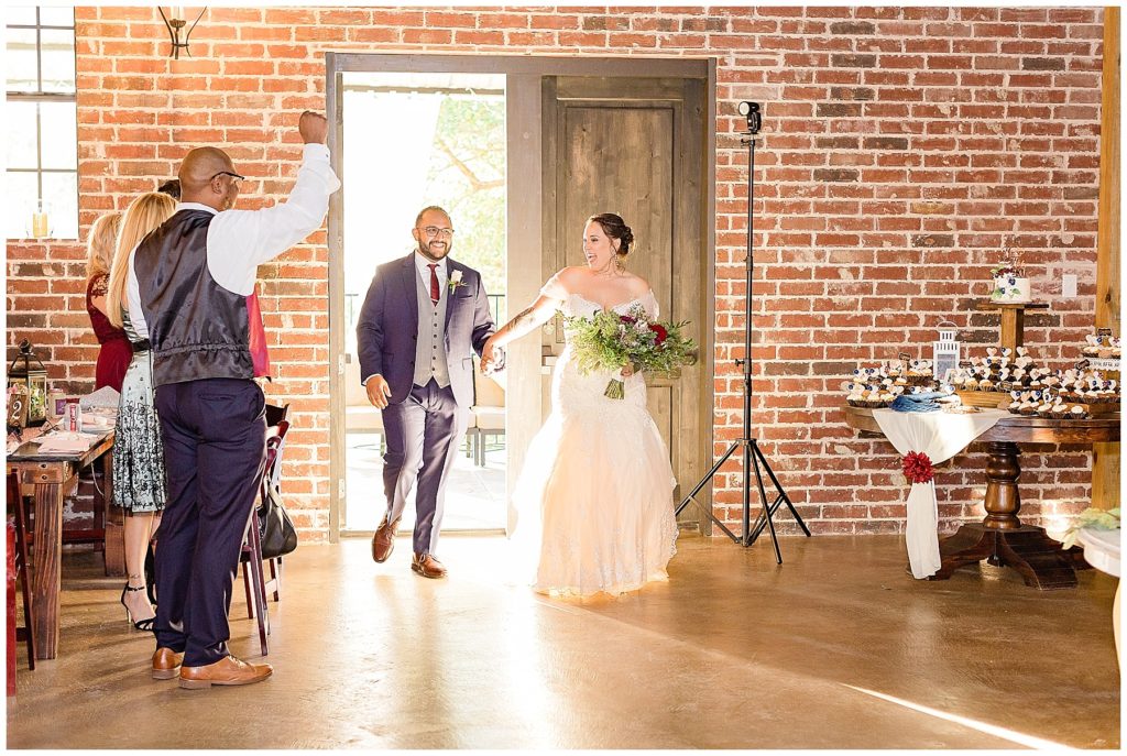 bride and groom walking into reception brick venue