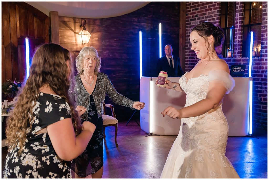bride dancing at reception with grandmother with media lights dj nate nelson