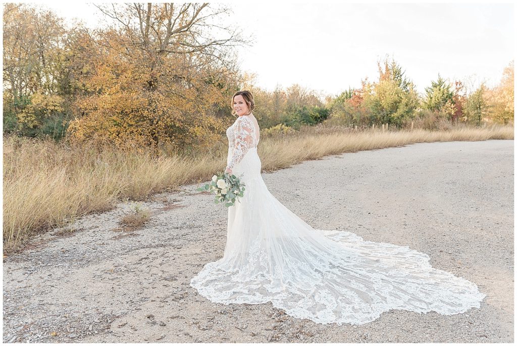 bride in cathedral length lace gown at clear creek nature preserve in denton texas