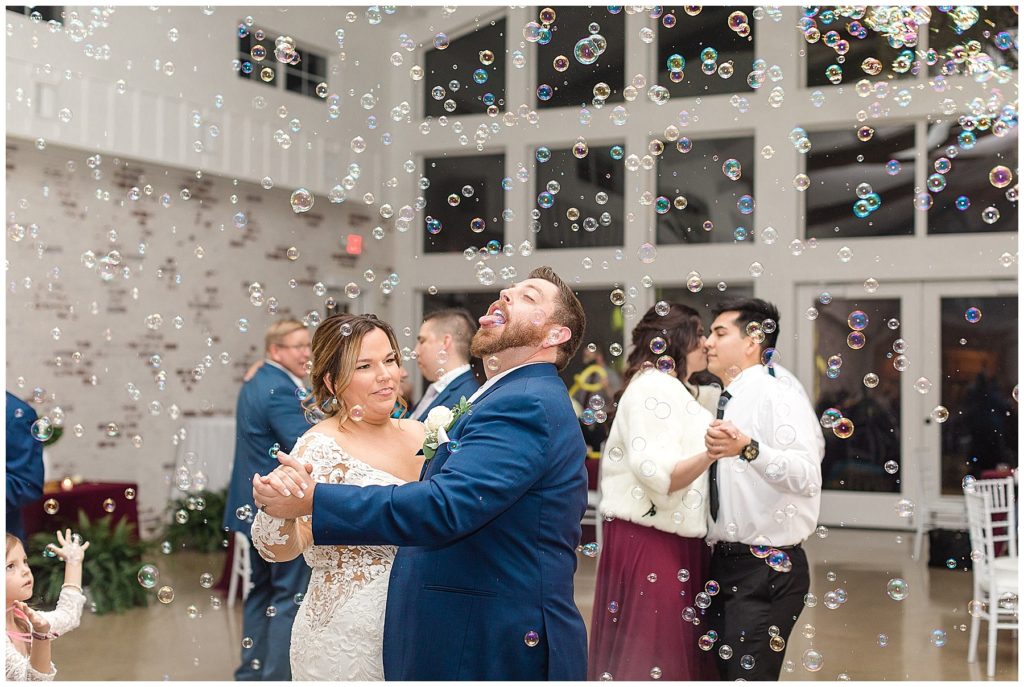 bride and groom dancing at reception with bubbles