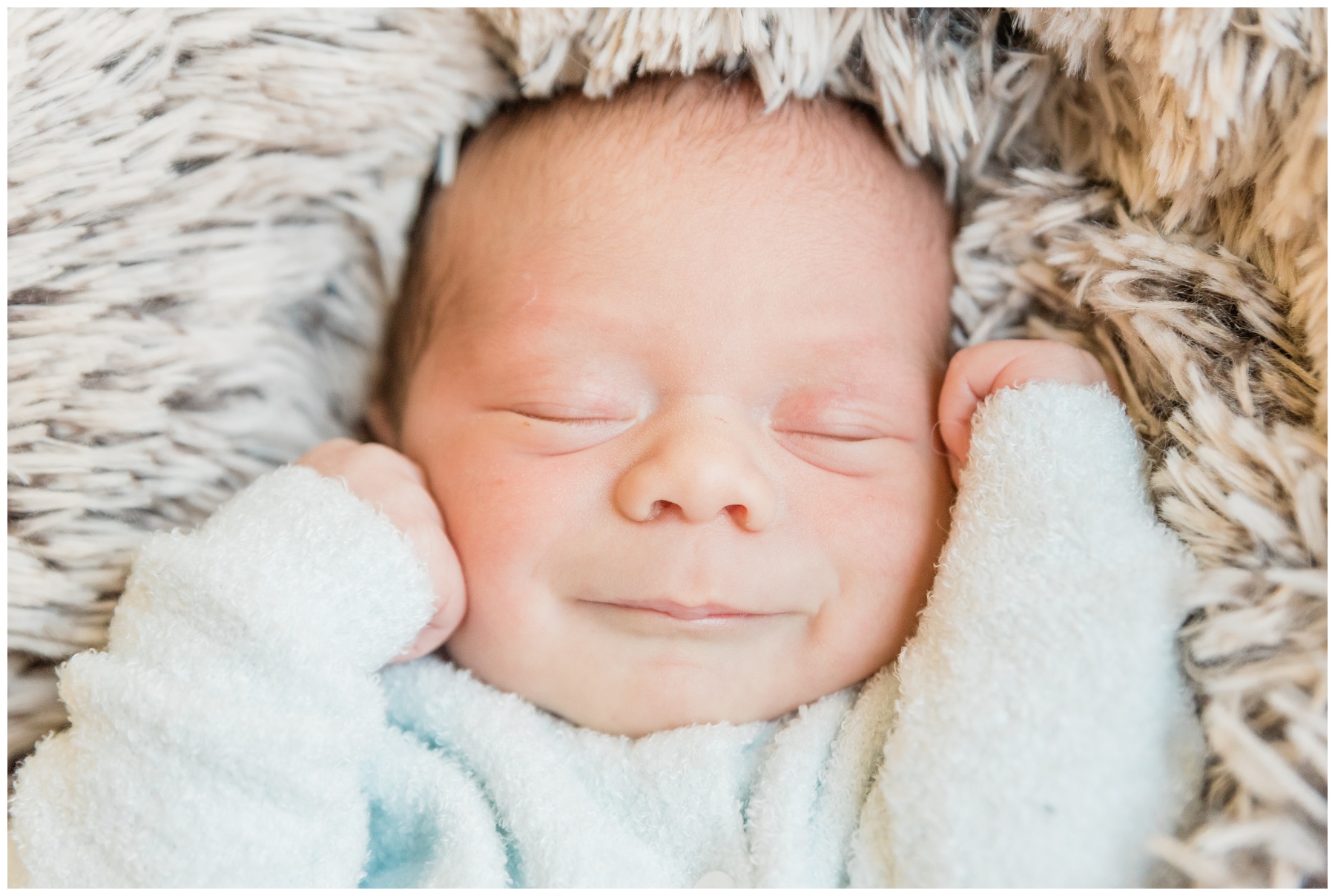 baby lays on fuzzy blanket during TX newborn photos