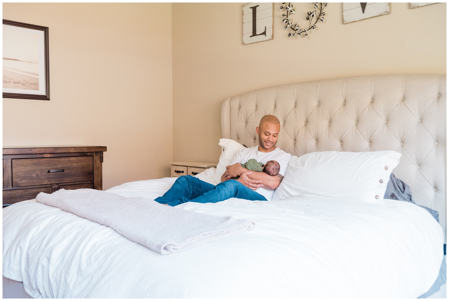dad snuggles with baby on bed during Dallas lifestyle newborn session