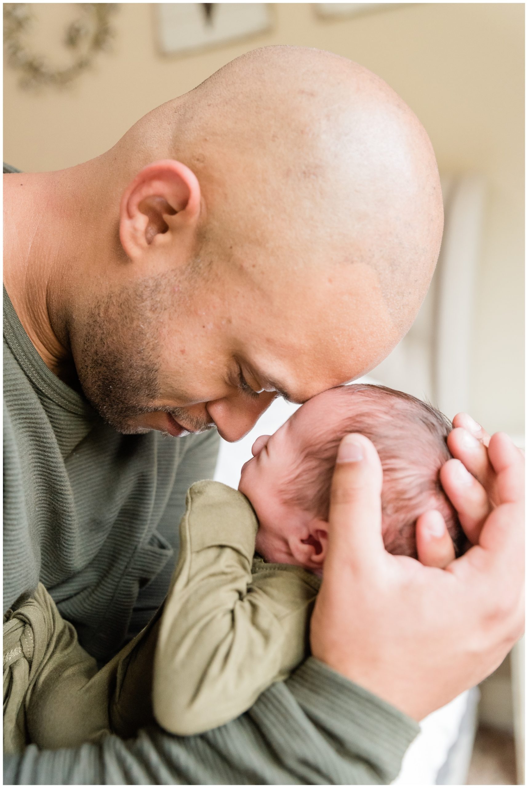 dad touches head with newborn baby boy in Frisco lifestyle newborn session