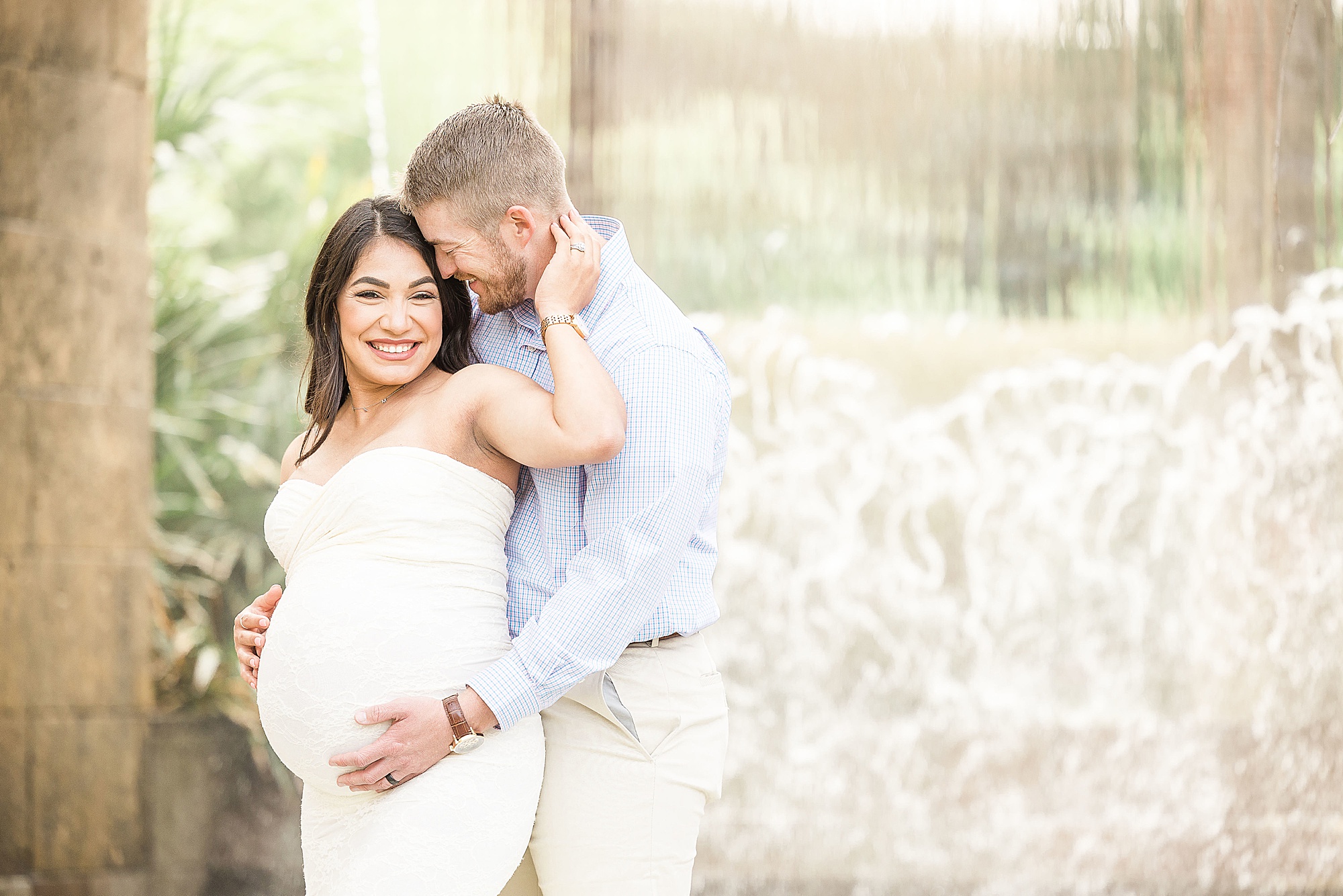 dad-to-be makes mom laugh during maternity session