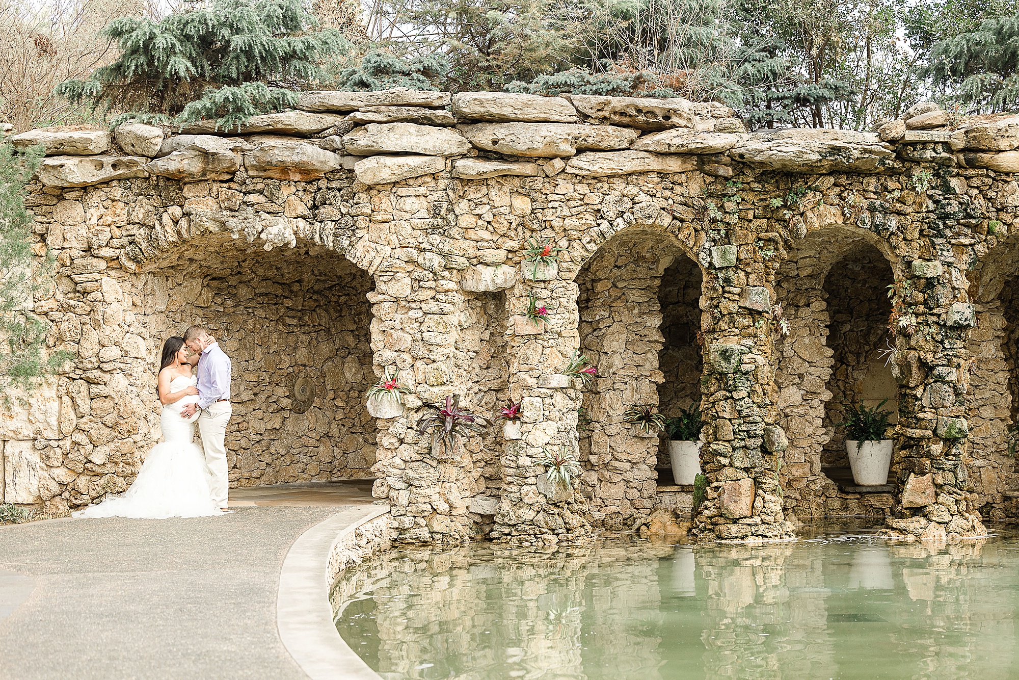 couple poses in stone walkway at Dallas Arboretum