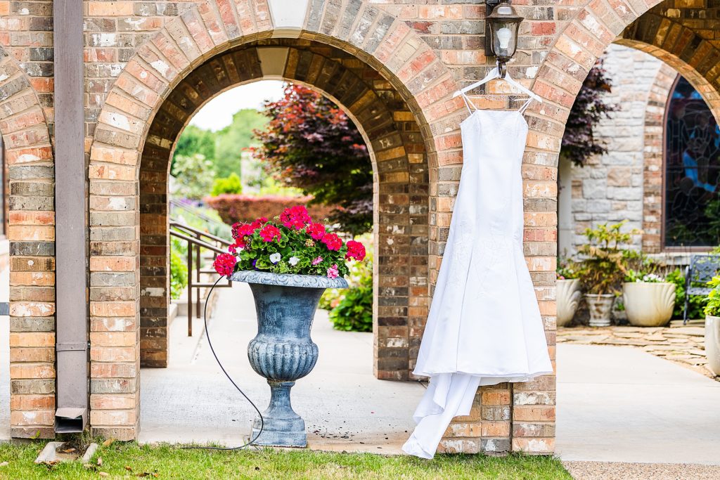 bride's dress hangs outside Church of Holy Communion