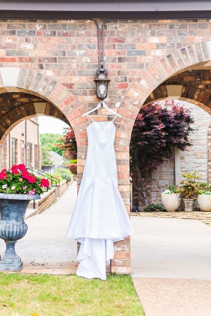 wedding gown hangs outside Church of Holy Communion