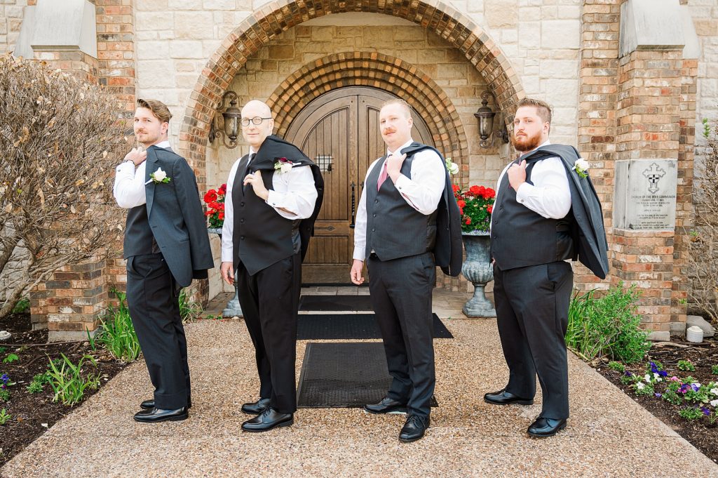 groom poses with groomsmen during Dallas X wedding 