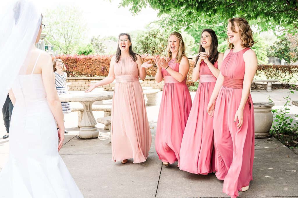 bridesmaids' first look with bride outside the Church of Holy Communion