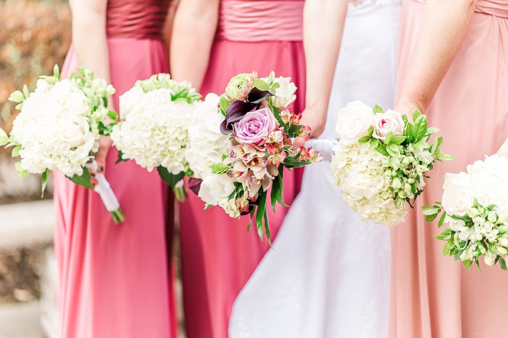 bridesmaids in pink holds bouquets for Dallas TX wedding