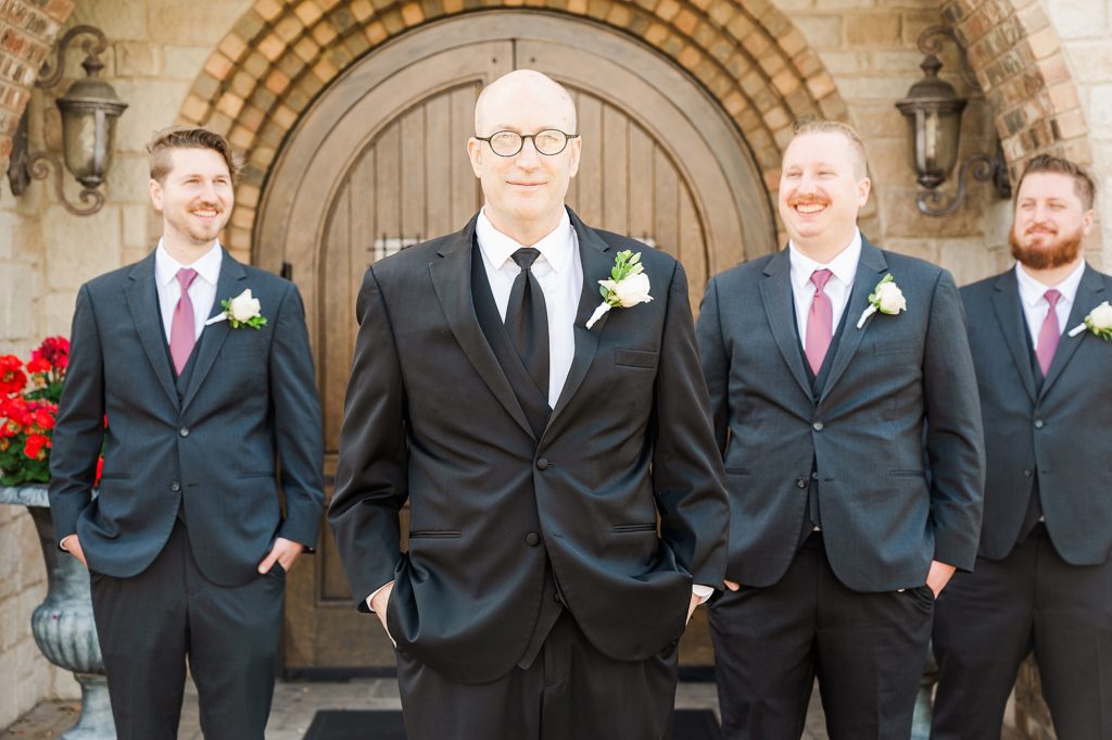 groom poses with groomsmen at the Church of Holy Communion