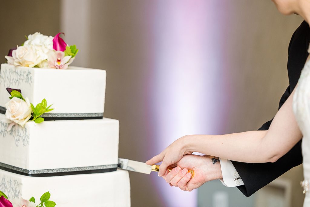 bride and groom cut wedding cake at Dallas Addison Marriott