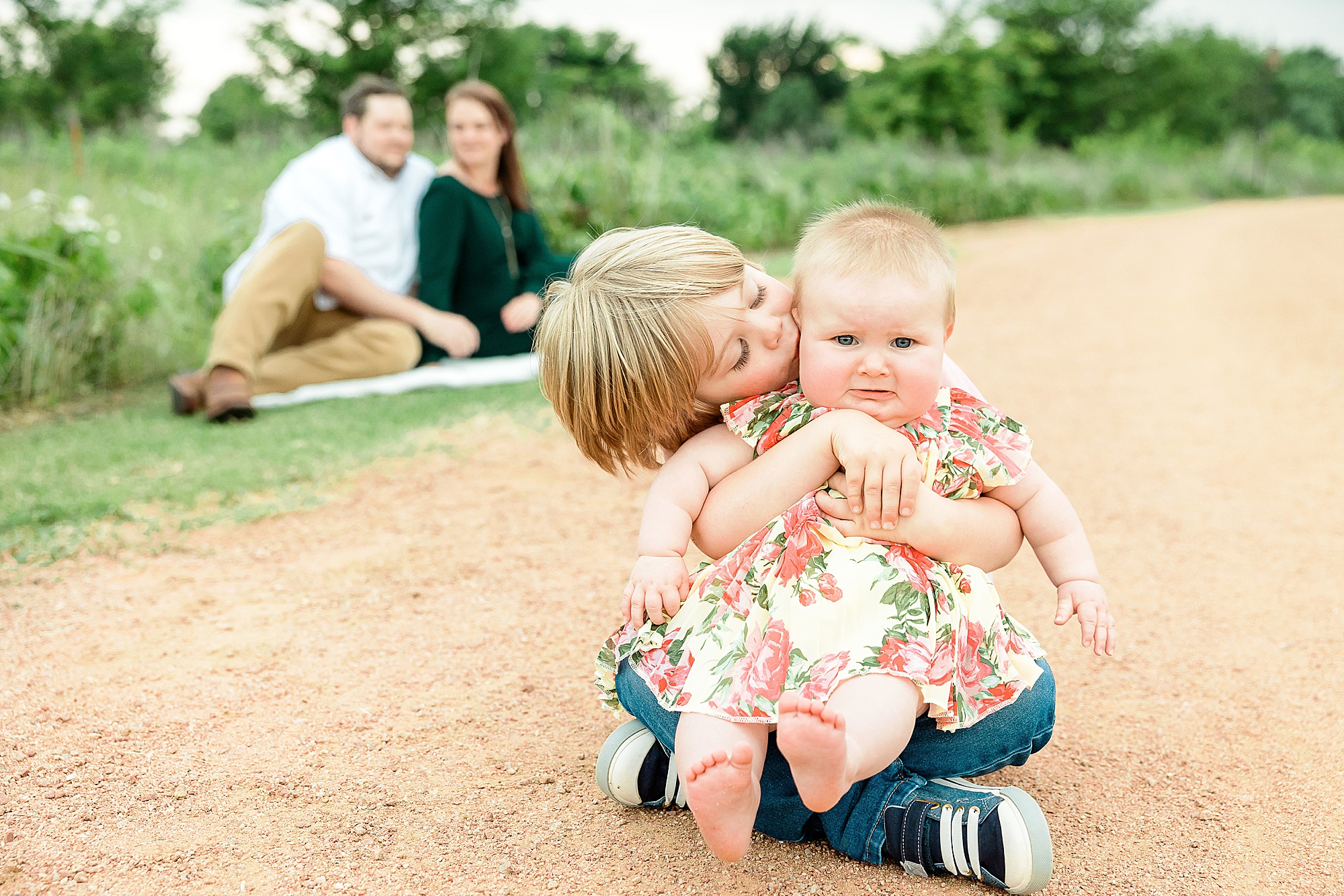 boy kisses little sister during Little Elm family portraits