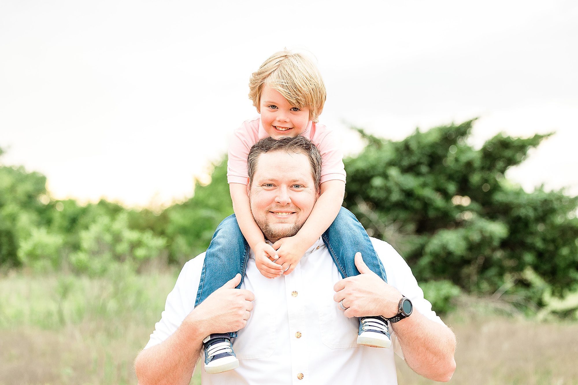 dad poses with son on shoulders during Little Elm family portraits