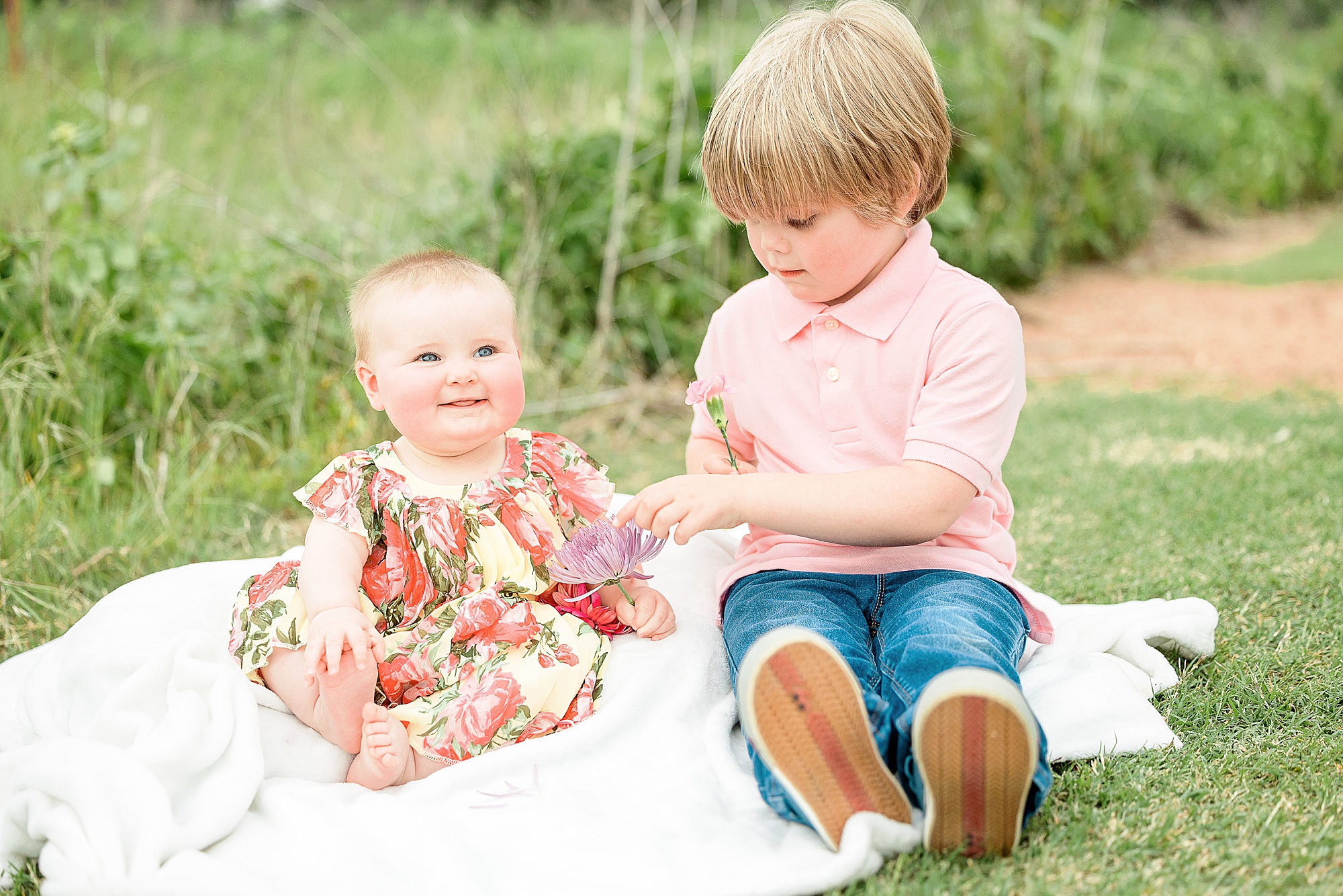 big brother plays with sister during family photos