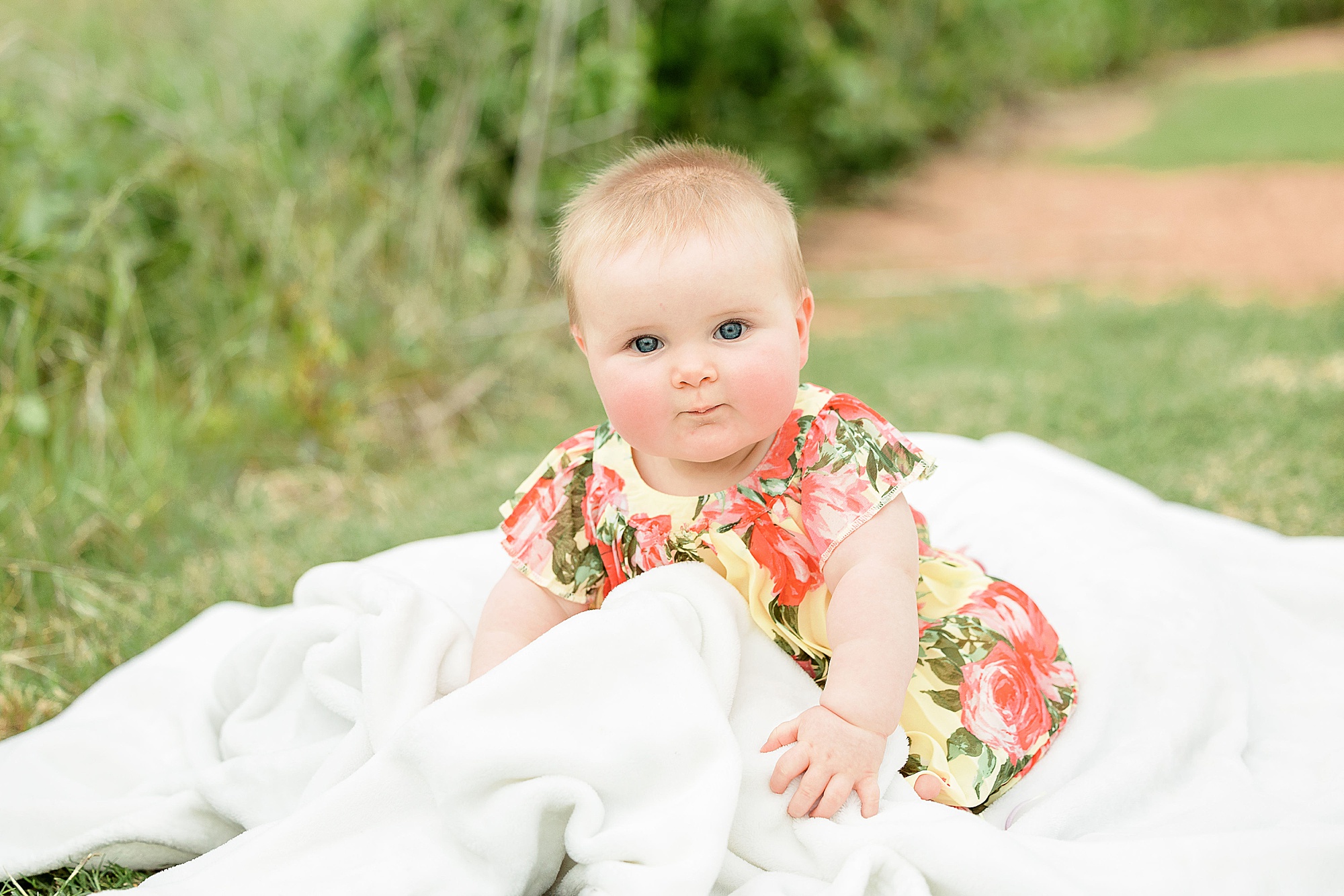 toddler plays in blanket during Little Elm family portraits