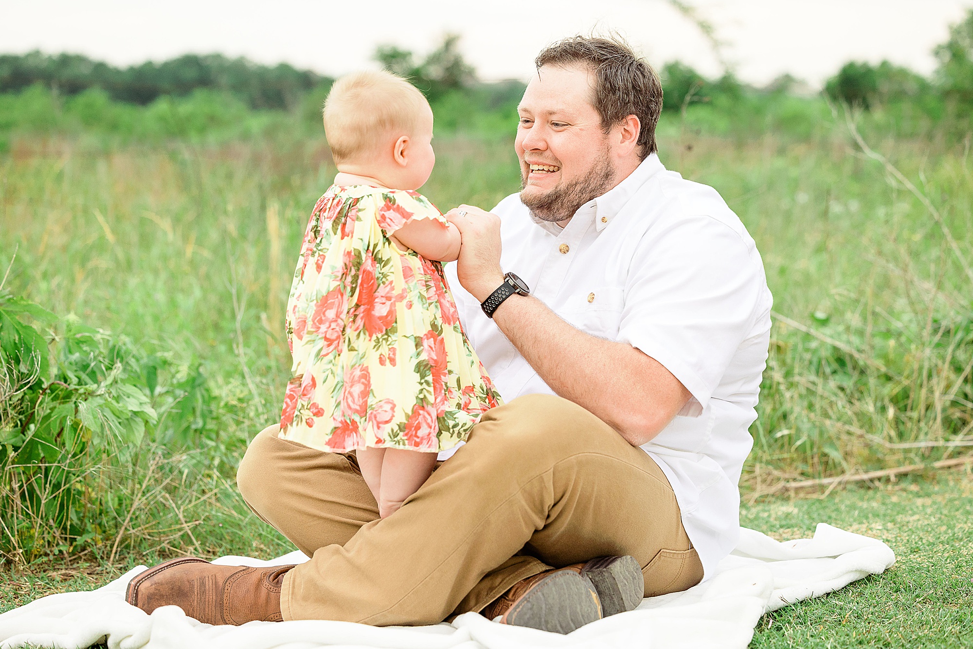 dad poses with toddler during family photos in Little Elm TX