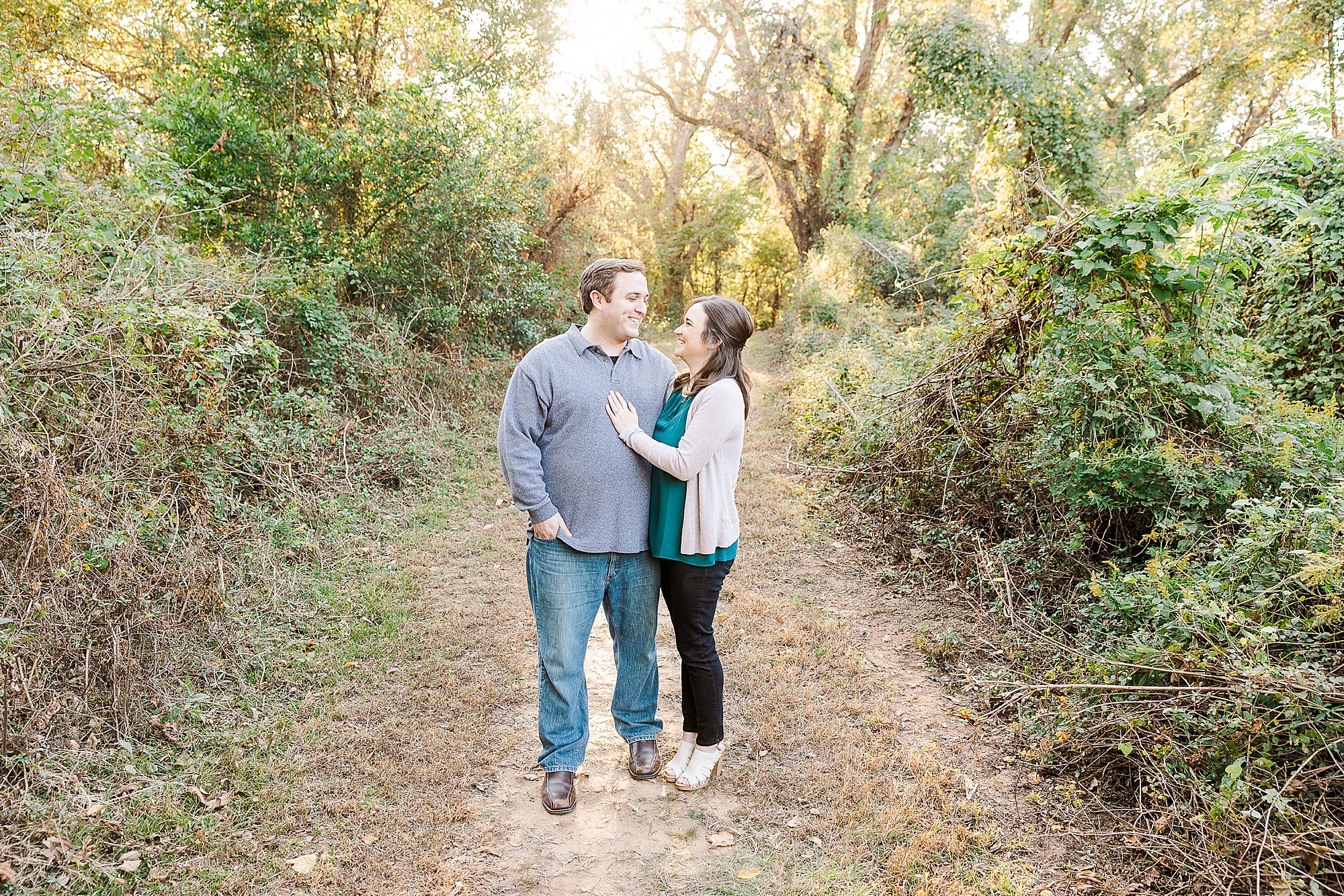 engaged couple stands on path during Shreveport engagement session