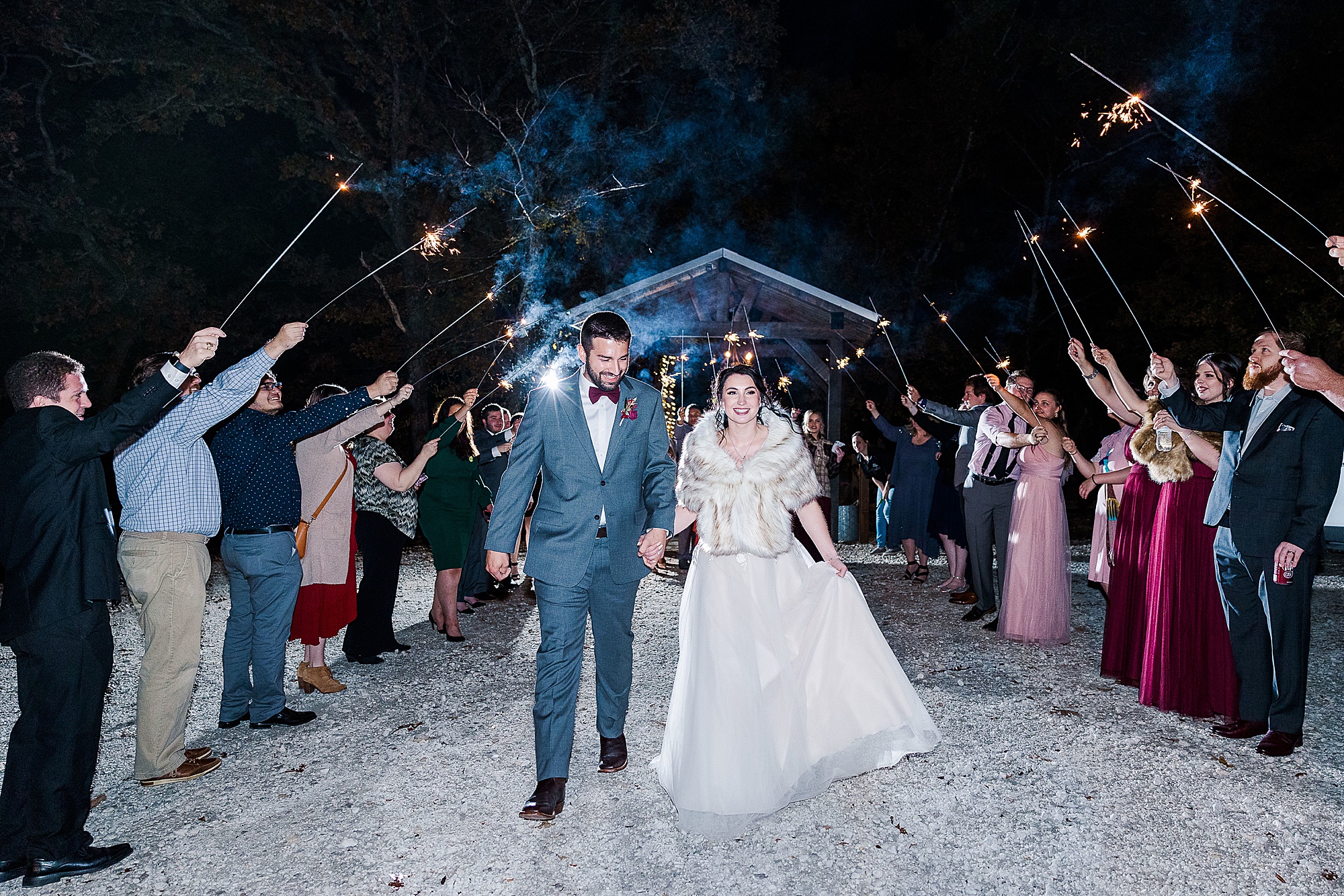 newlyweds leave wedding reception at Whispering Oaks in sparkler exit