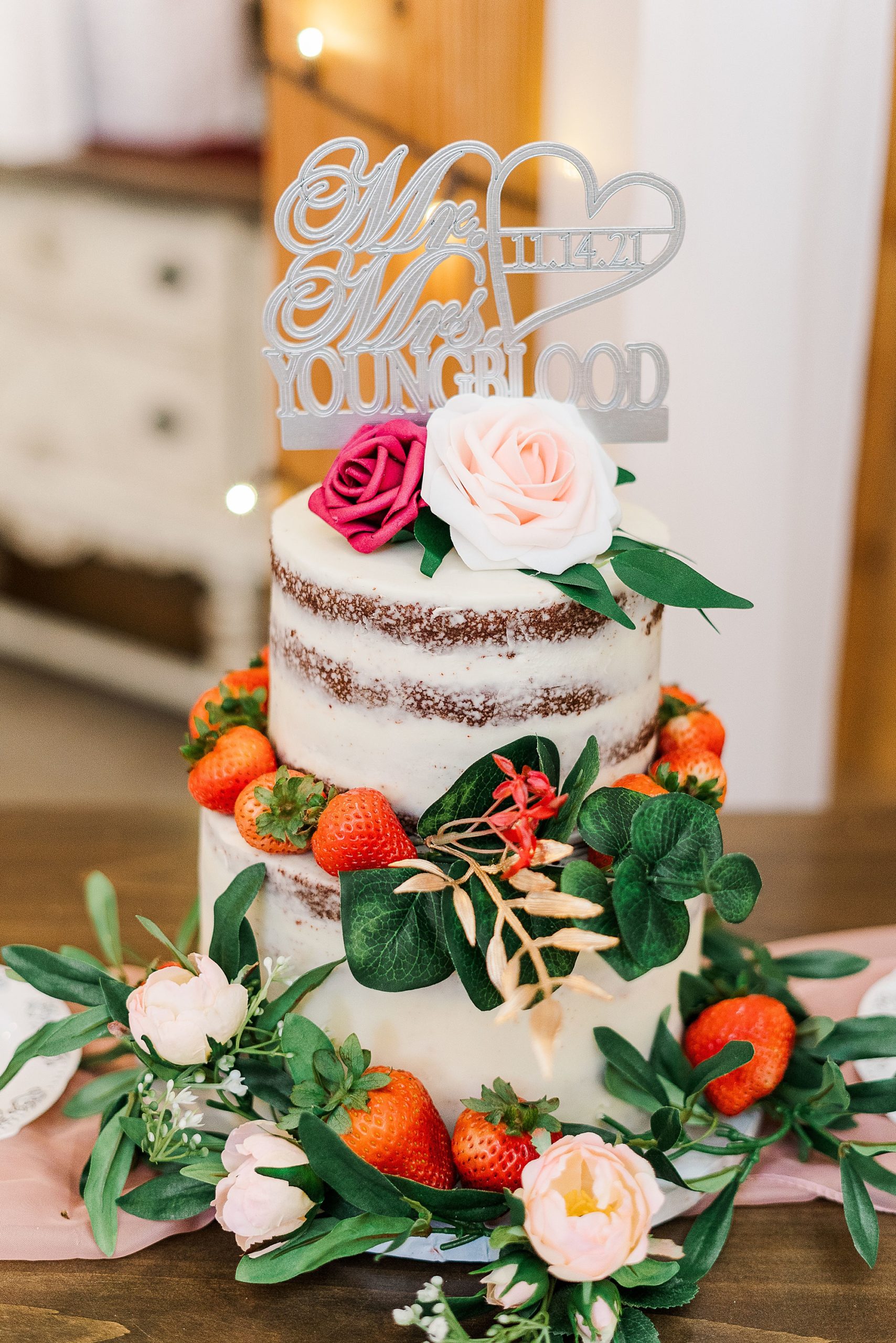 tiered naked wedding cake with silver sign