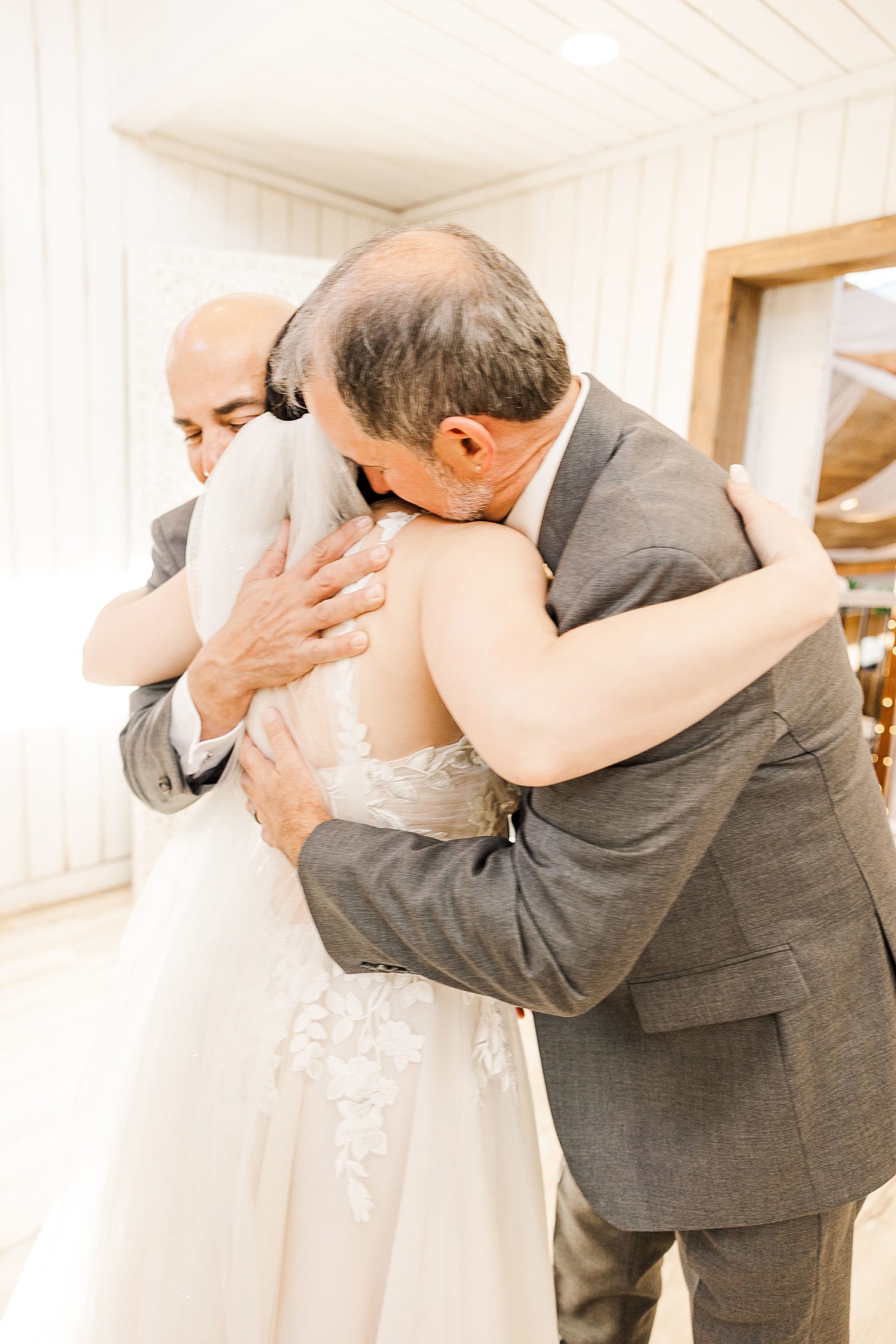 bride hugs dad during first look
