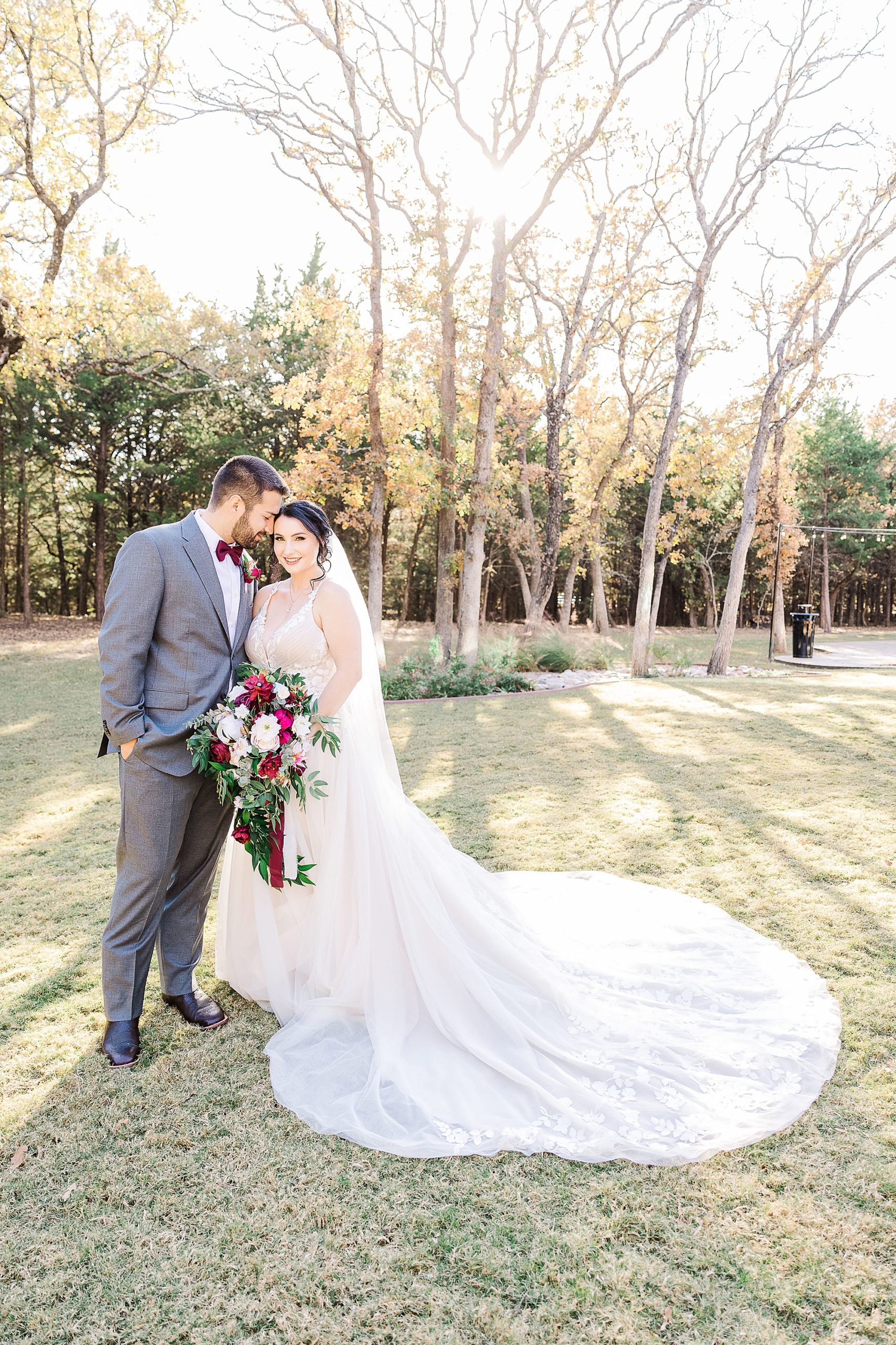 bride and groom stand together during Whispering Oaks wedding portraits