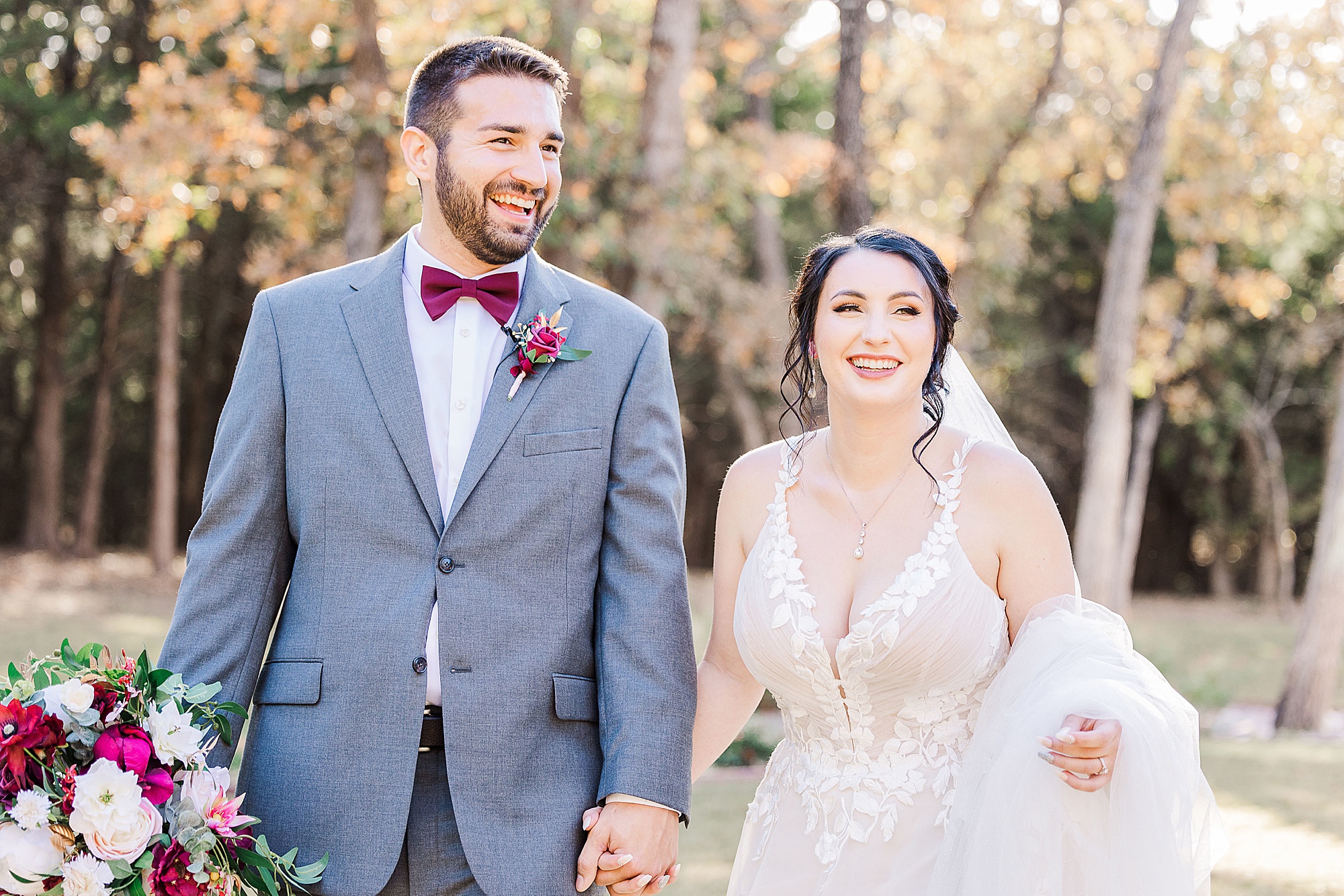 newlyweds hold hands walking together on wedding day