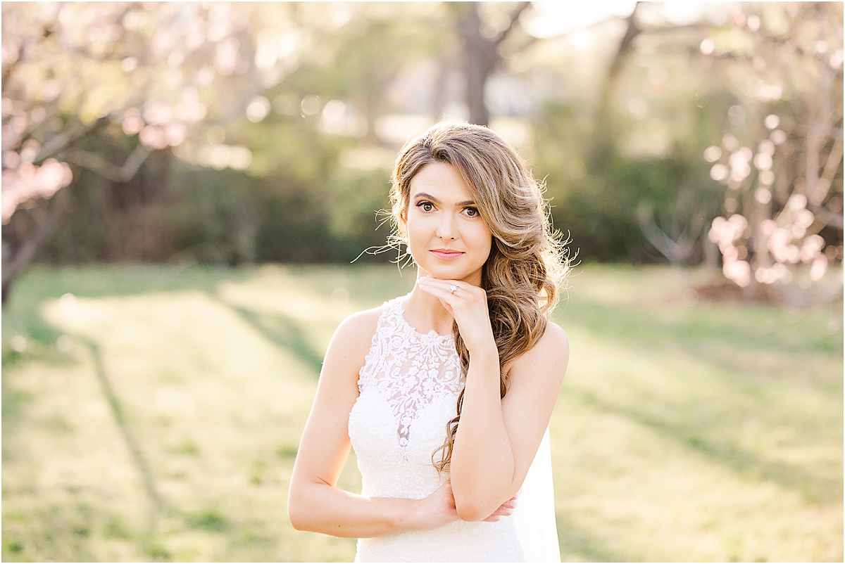 bride in white lace front gown in peach orchard