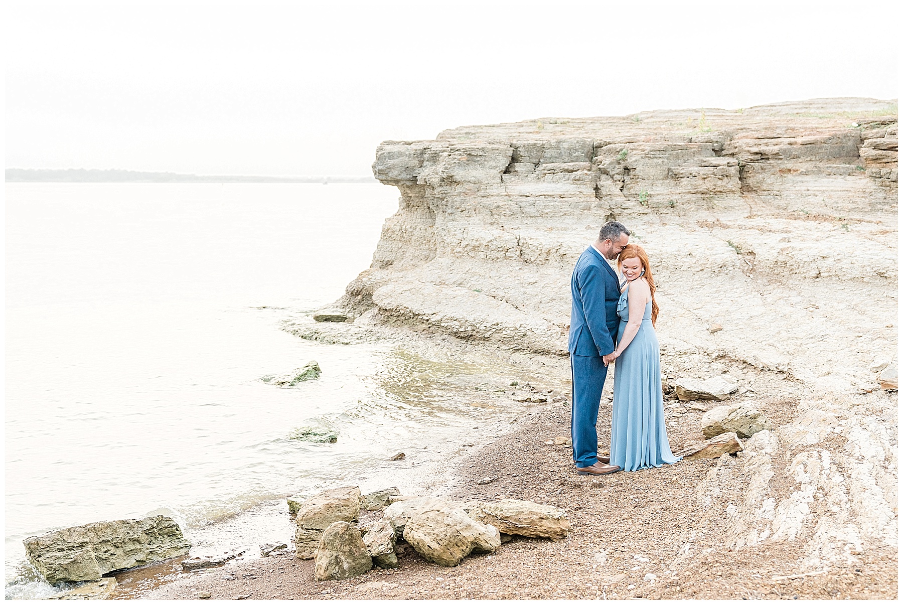 engaged couple by cliff at rockledge park in grapevine texas blue dress