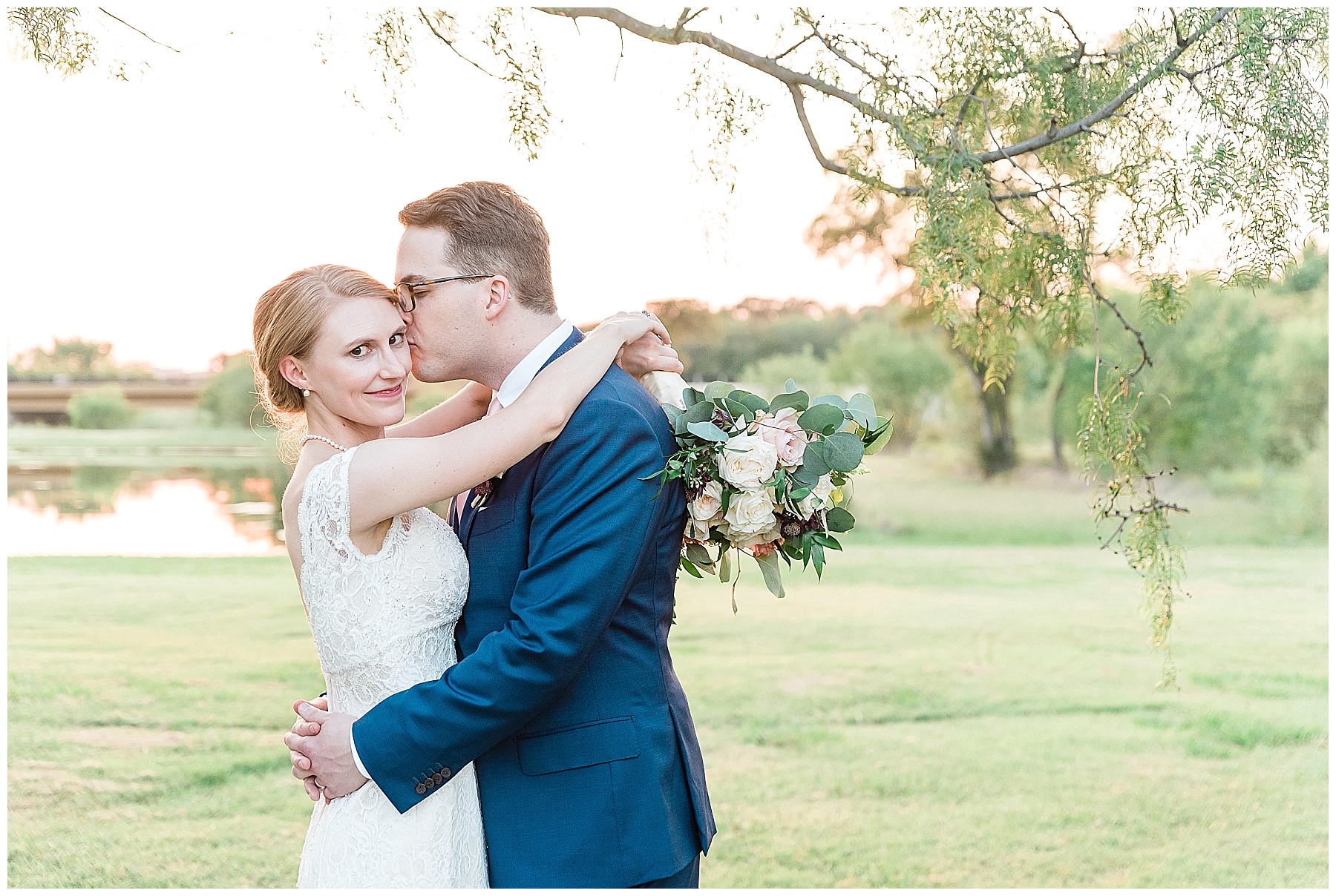 bride and groom snuggling at sunset with white rose bouquet