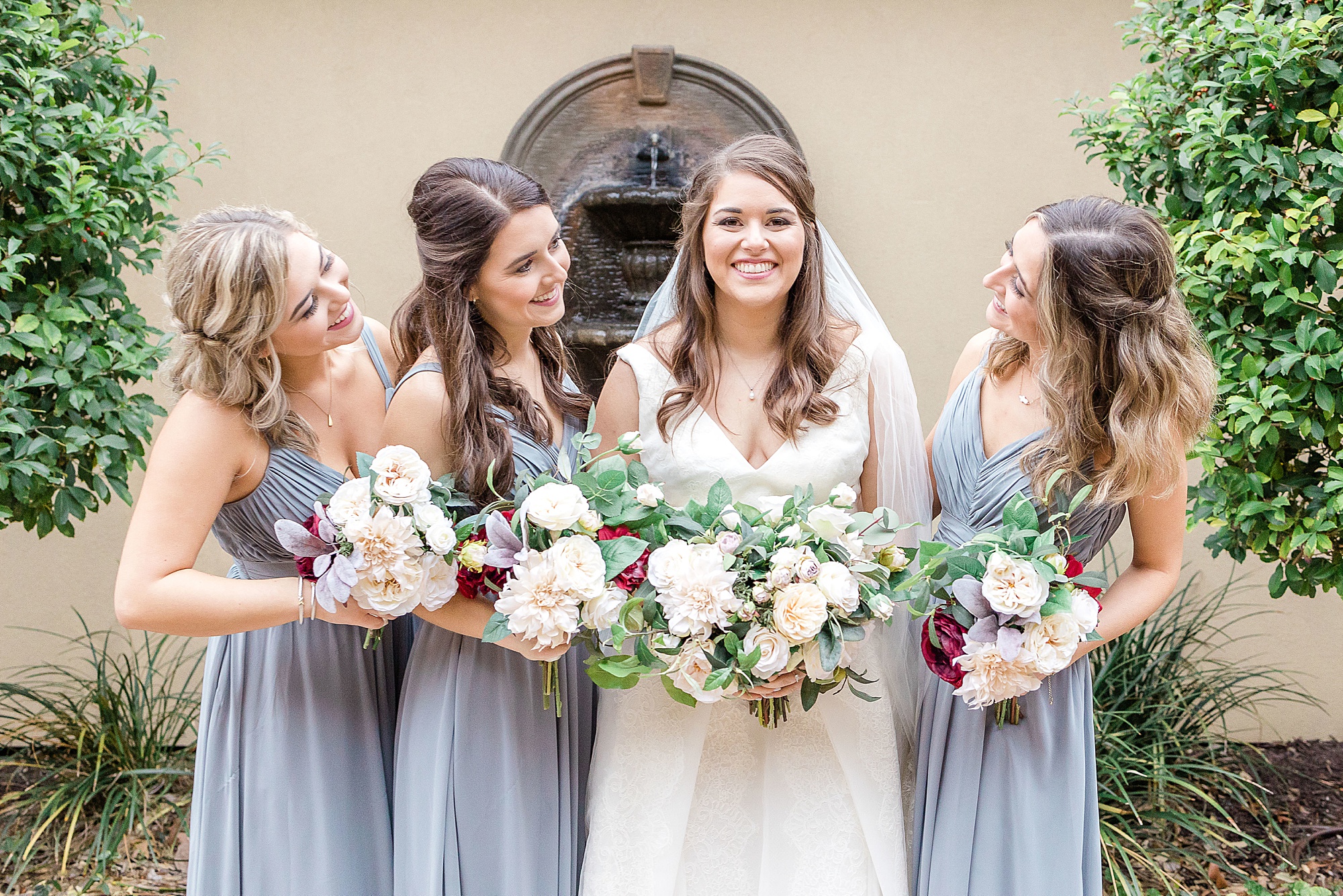 bridesmaids look at bride during TX wedding photos 