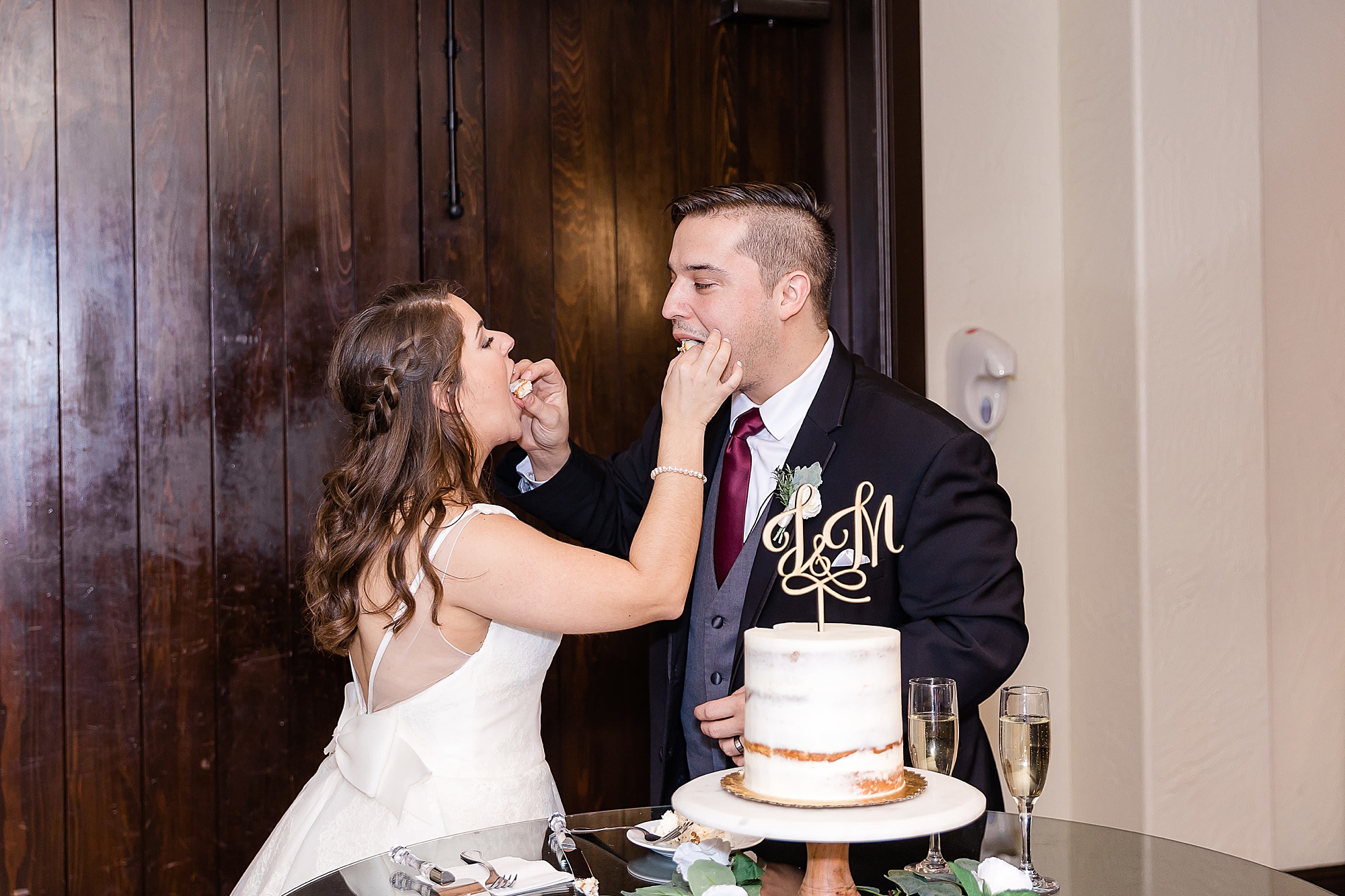 bride and groom feed each other cake during Texas wedding reception