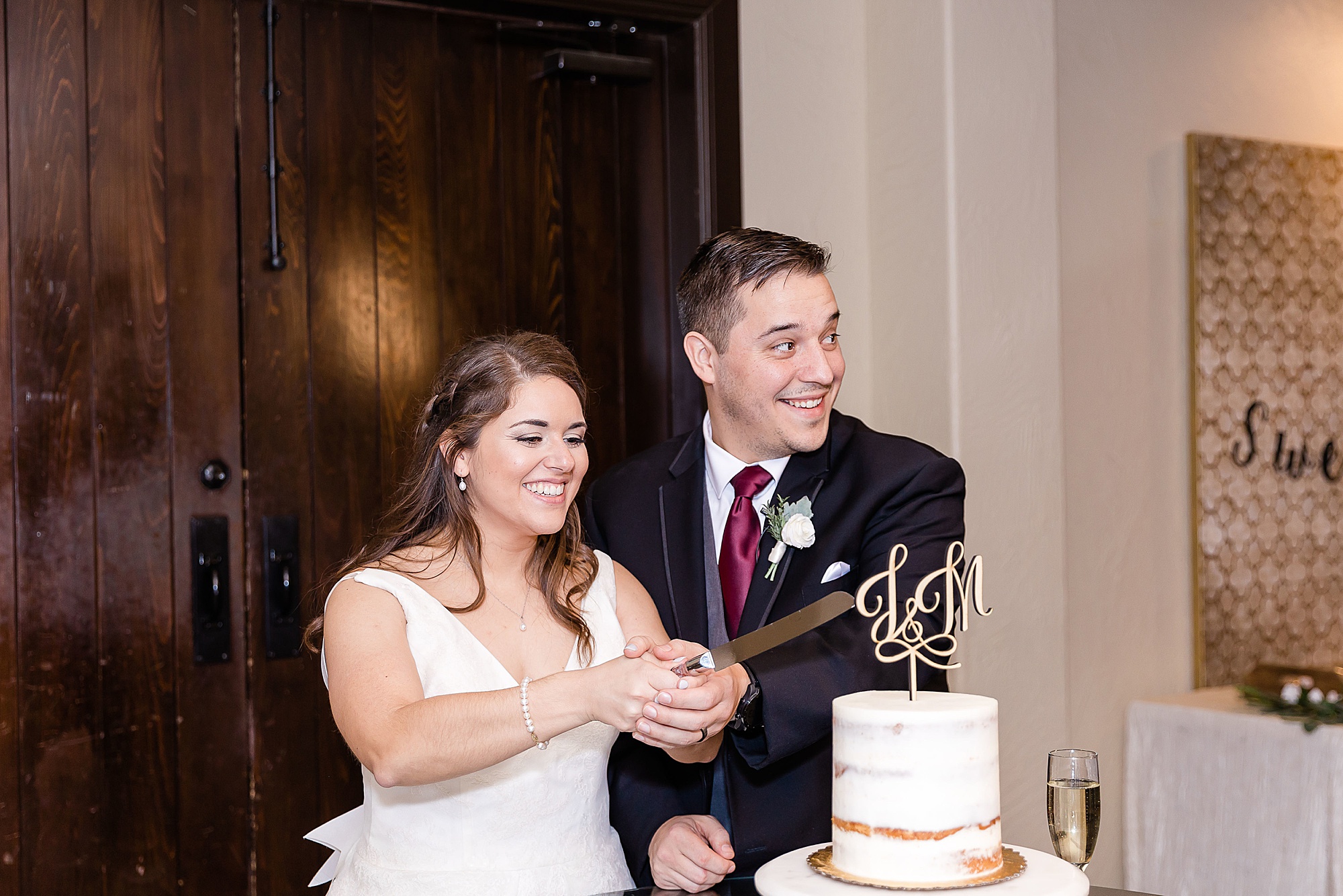 bride and groom cut wedding cake at Texas wedding reception
