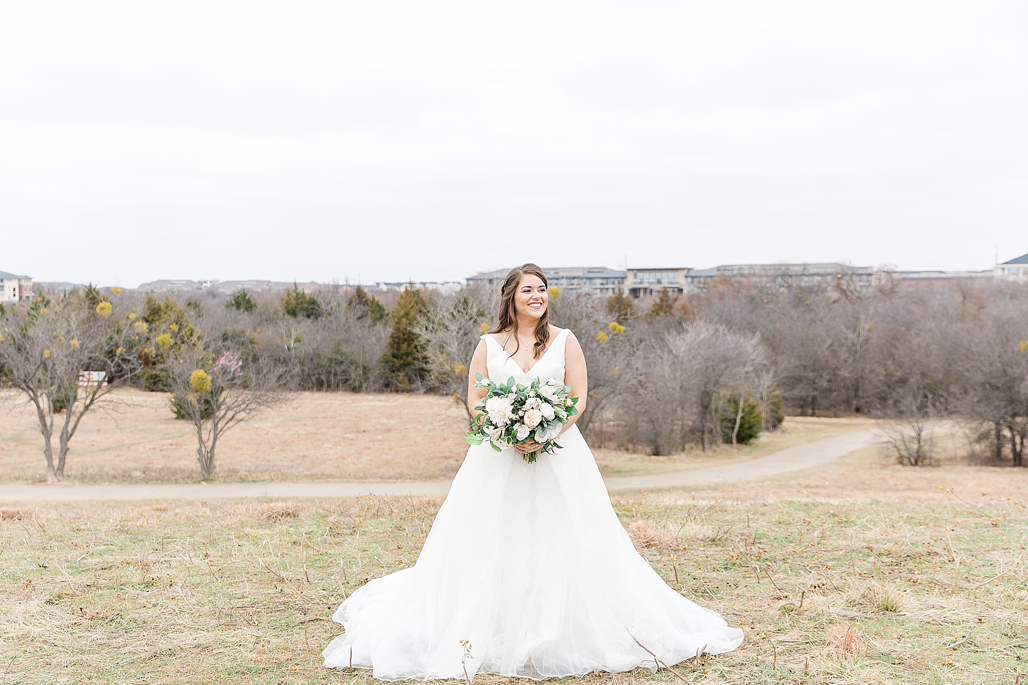 bride holds bouquet while standing in Arbor Hills Nature Preserve