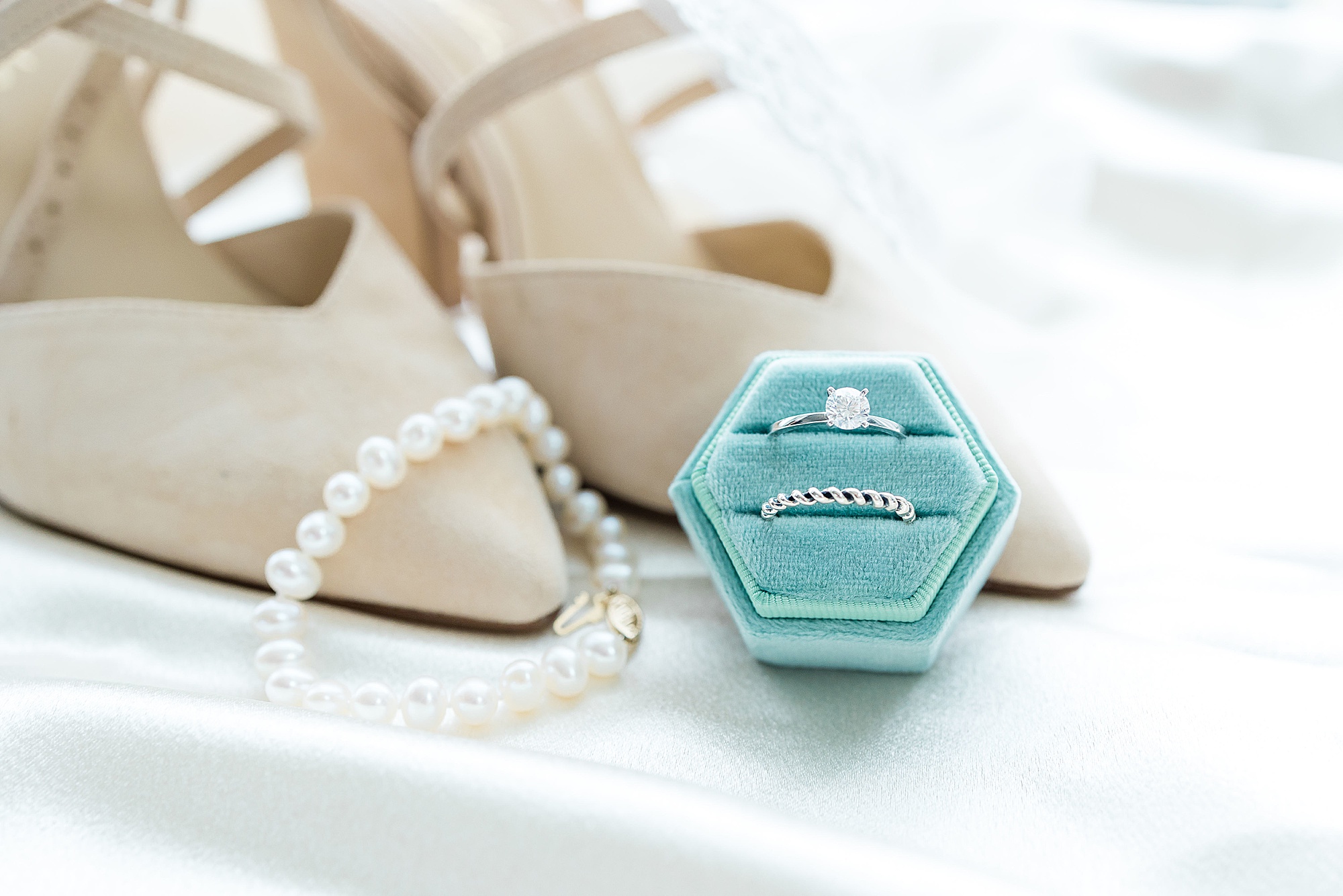 bride's rings rest against nude heels