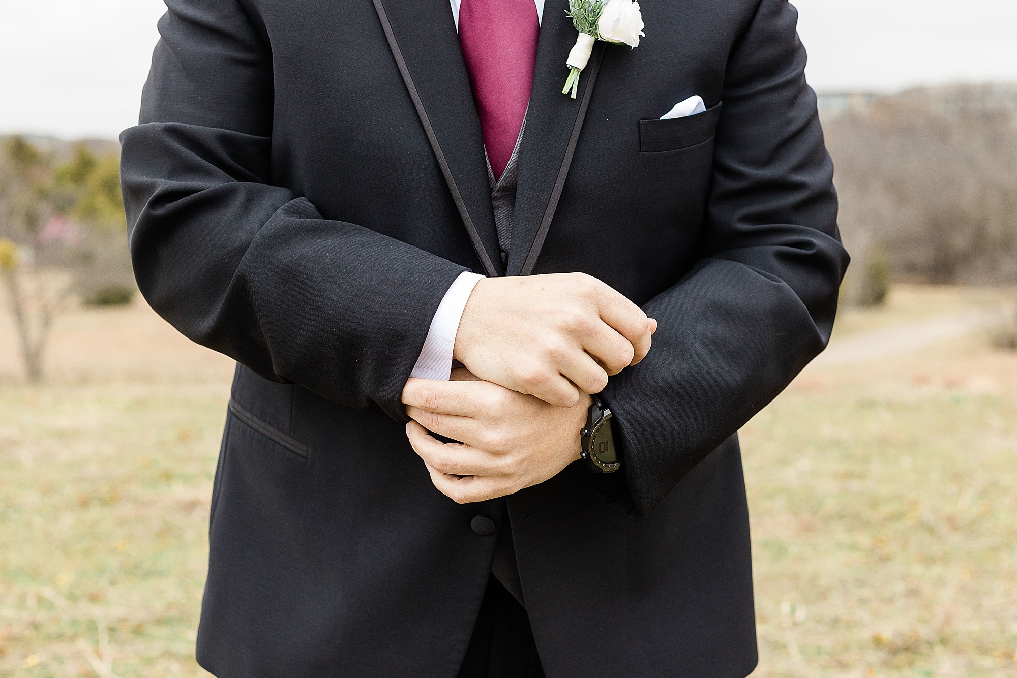 groom adjusts cufflinks before Chapel at Ana Villa wedding portraits 