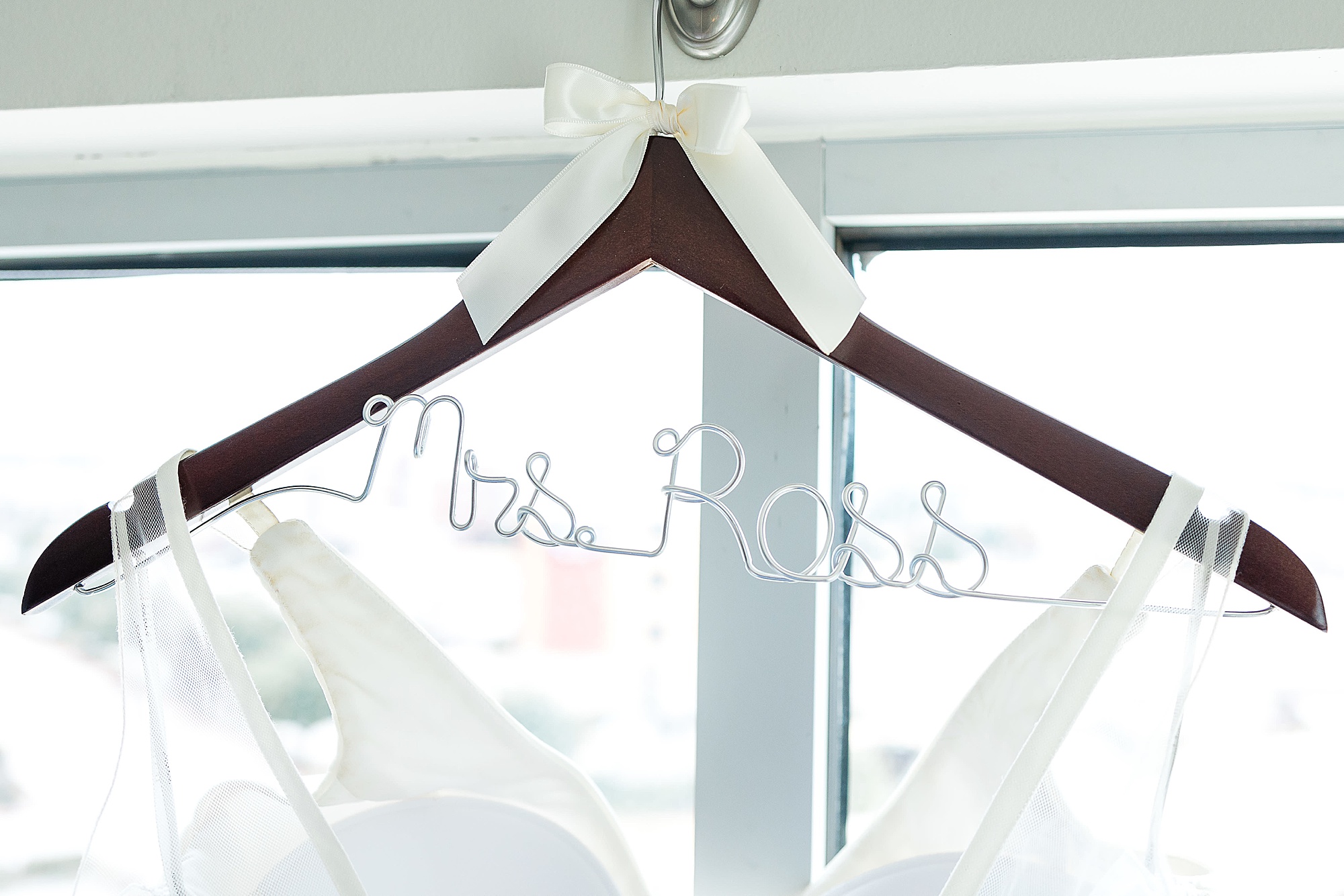 custom wedding hanger for bridal gown in Texas window