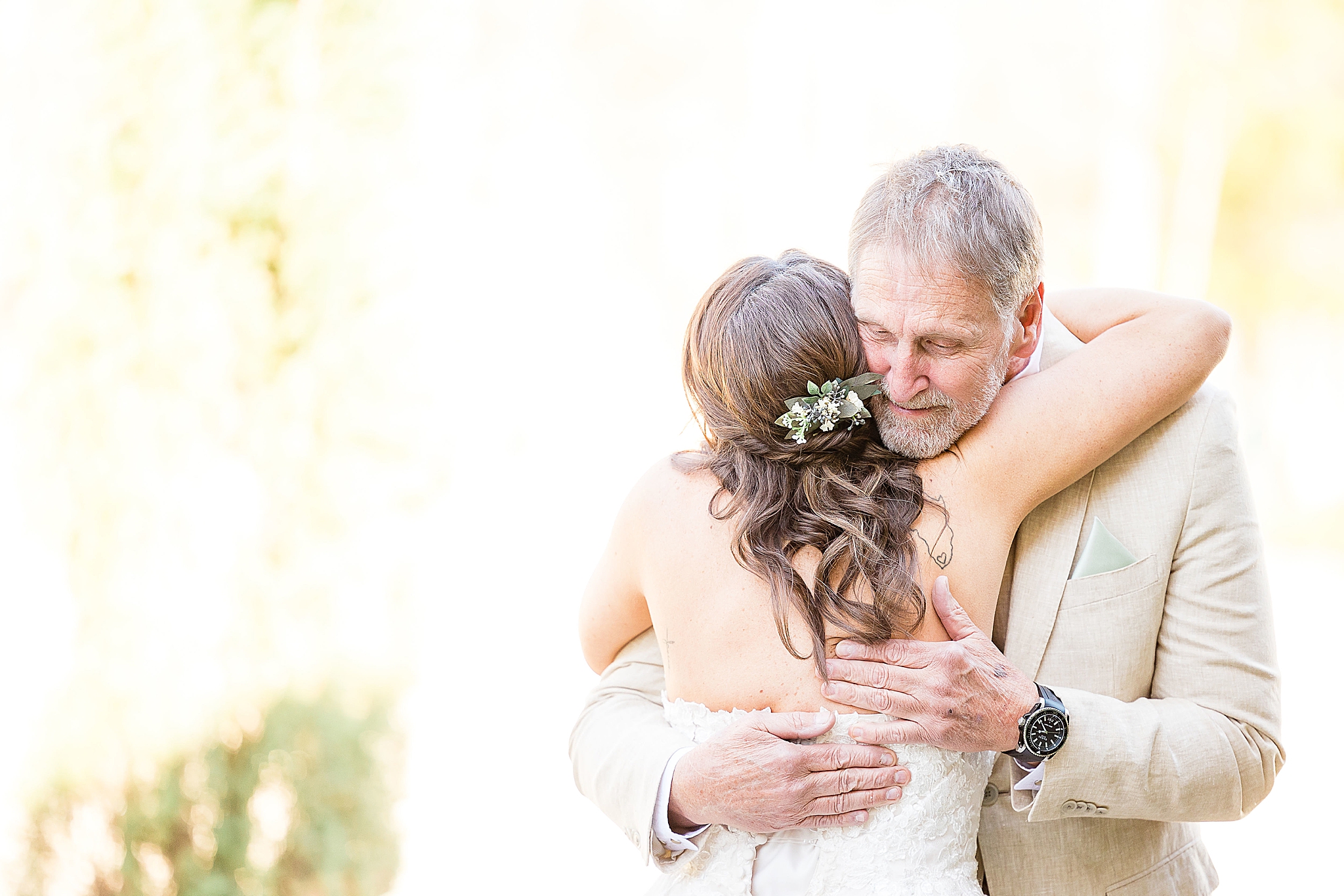 bride and grandfather hug during first look