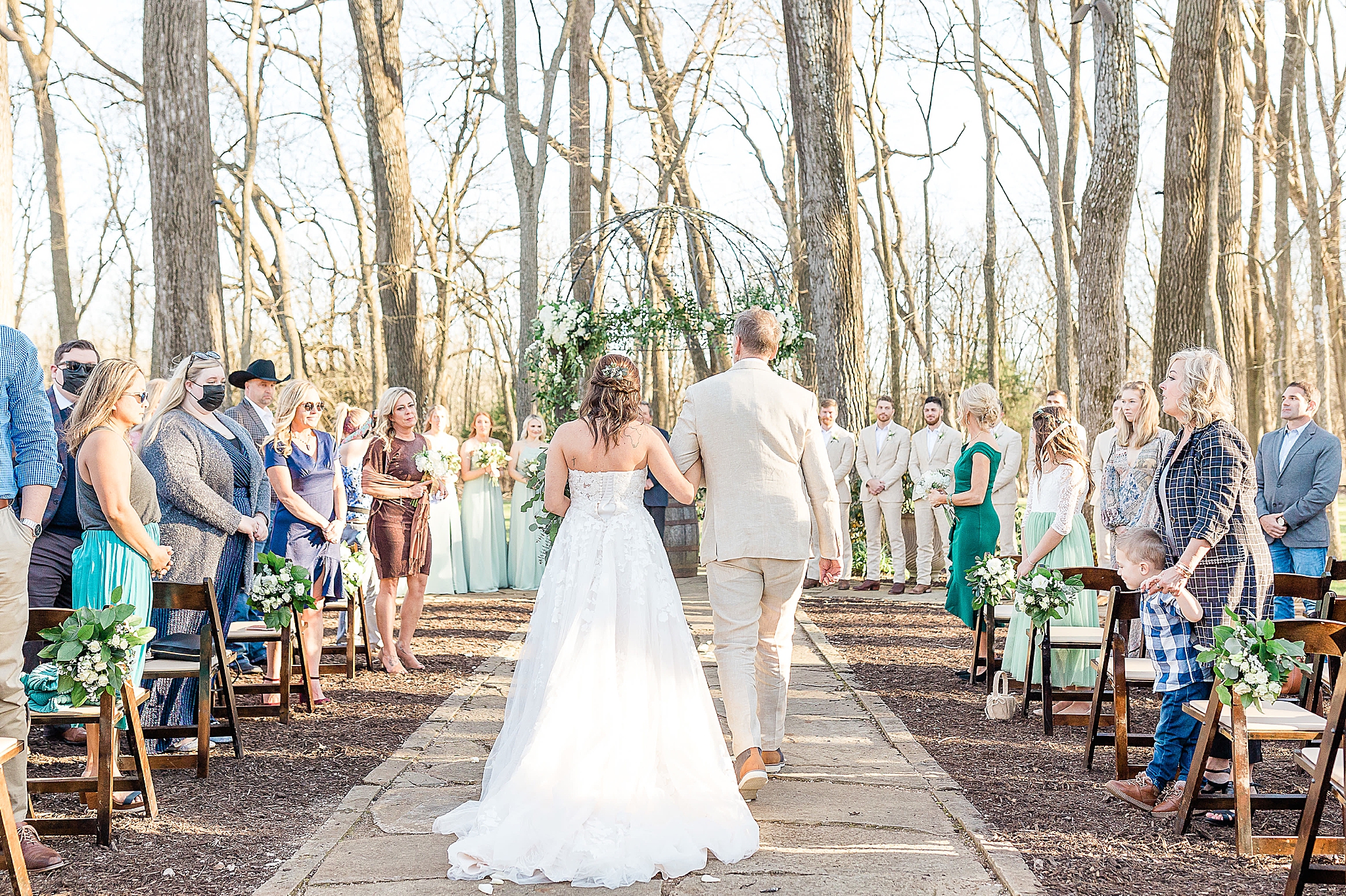 bride and grandfather walk together during Hidden Waters wedding ceremony