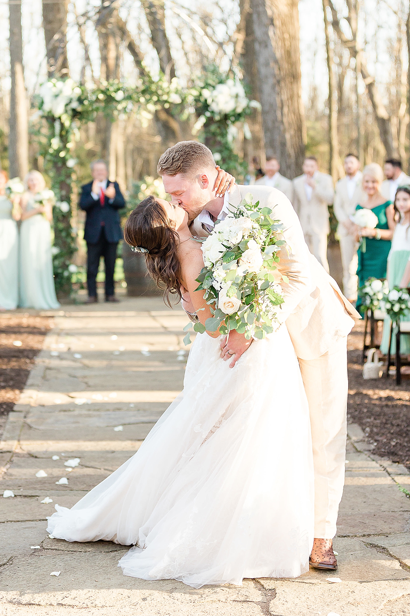 newlyweds kiss at end of aisle after Hidden Waters wedding ceremony