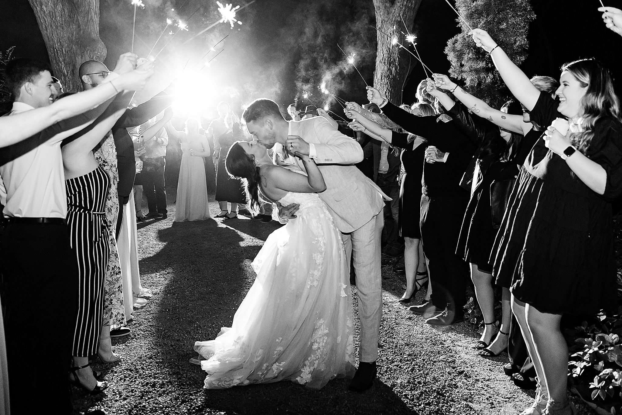 bride and groom kiss during sparkler exit