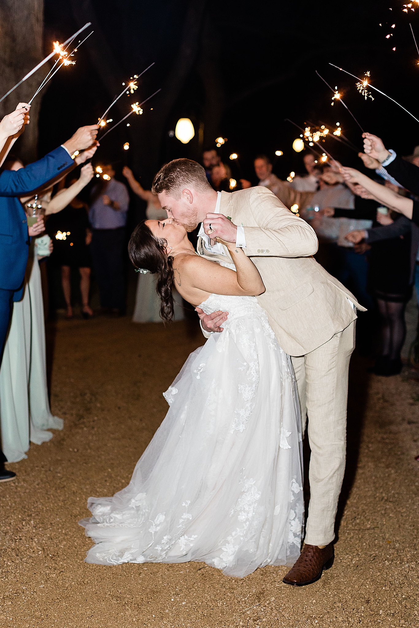 bride and groom kiss during sparkler exit from Hidden Waters wedding reception