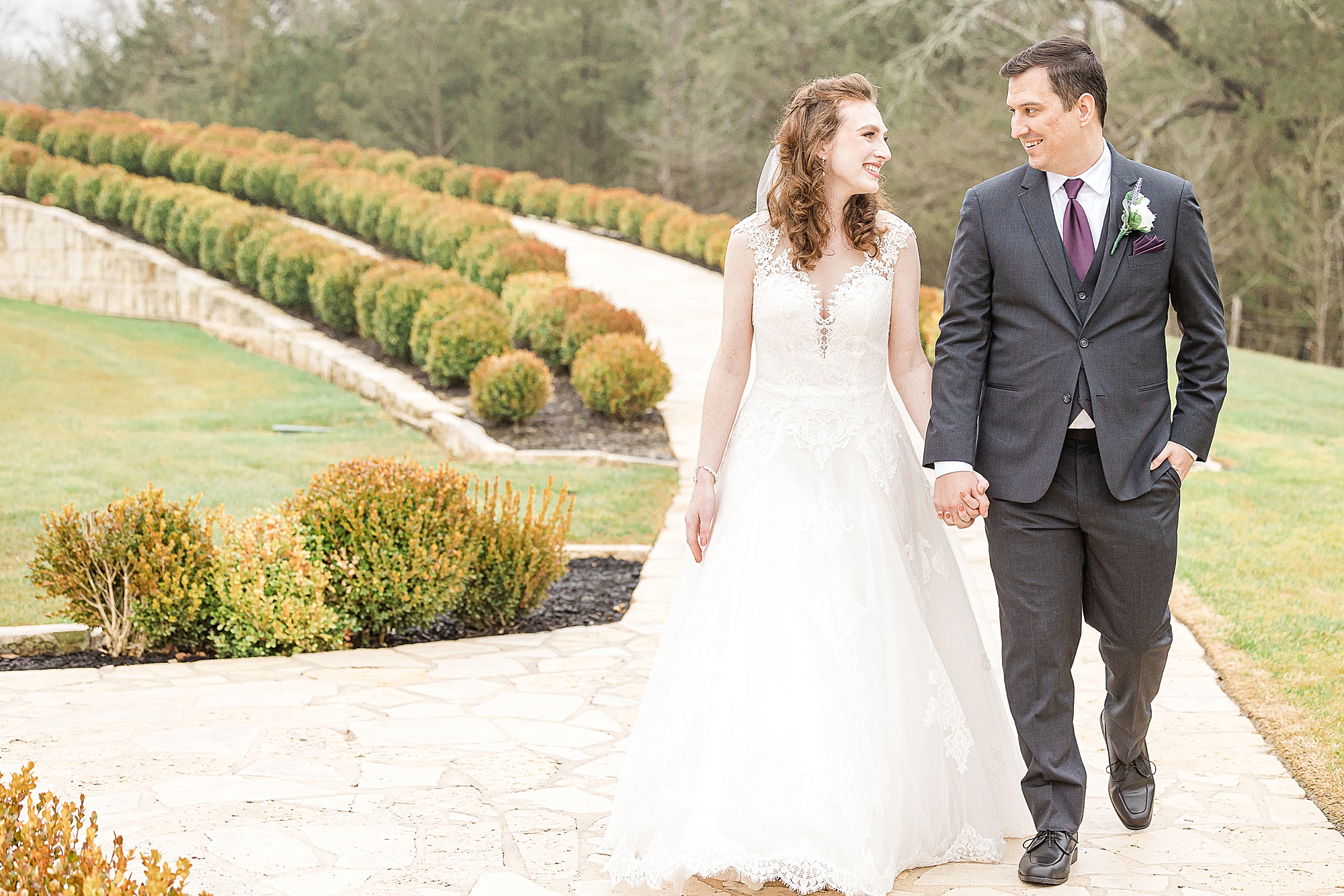 bride and groom walk around Stone Hall at the Springs