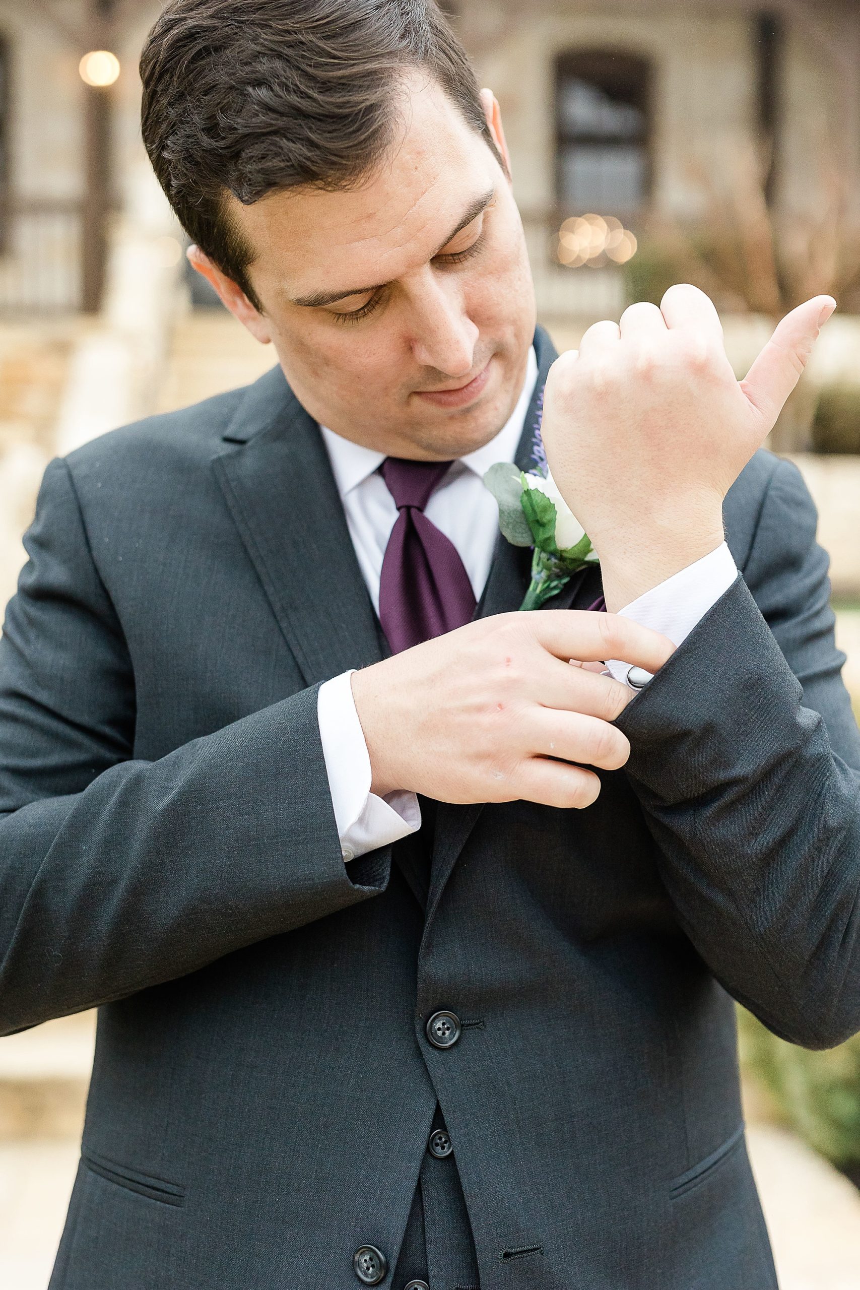 groom adjusts cufflinks before Stone Hall at the Springs wedding