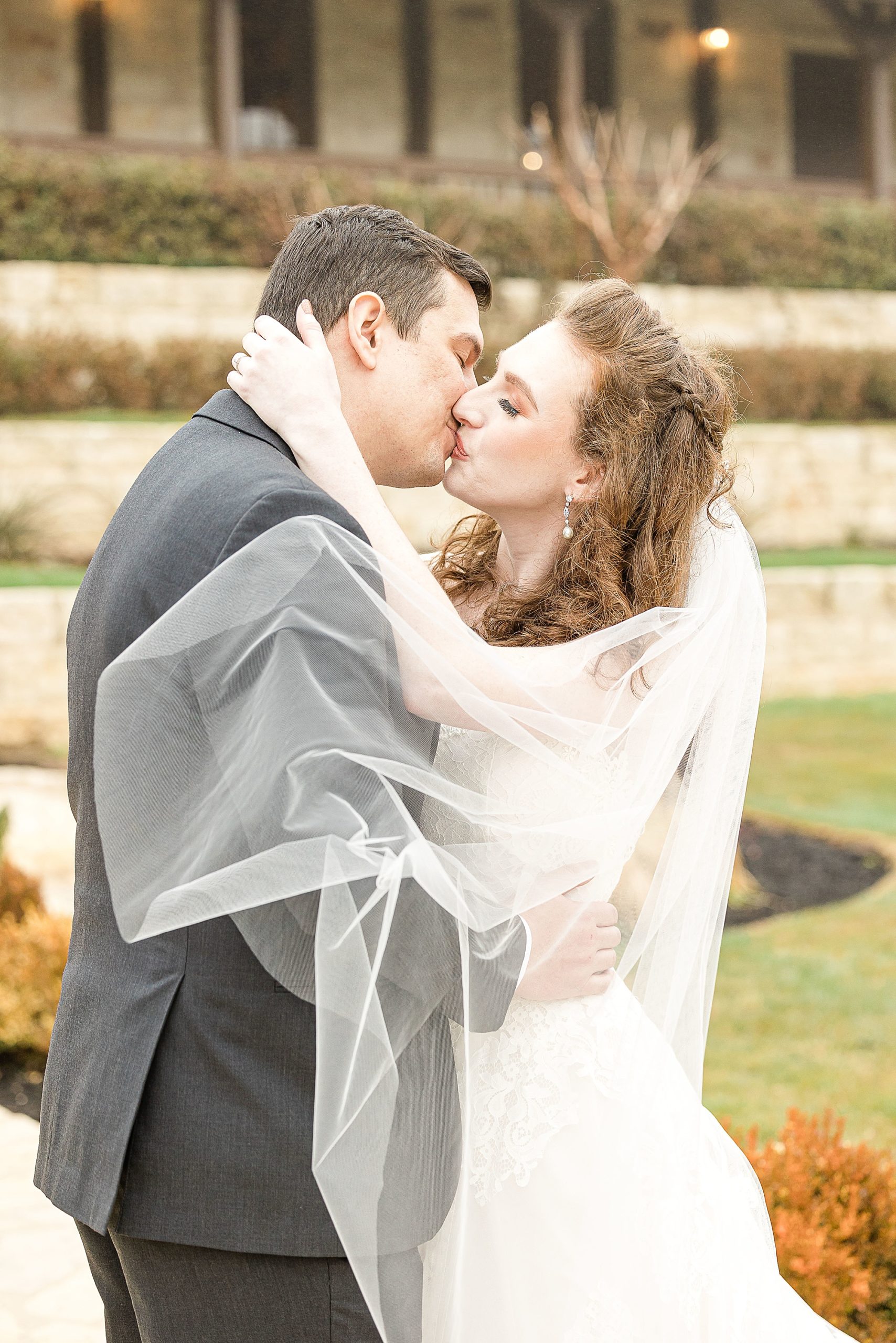 newlyweds kiss during TX wedding photos