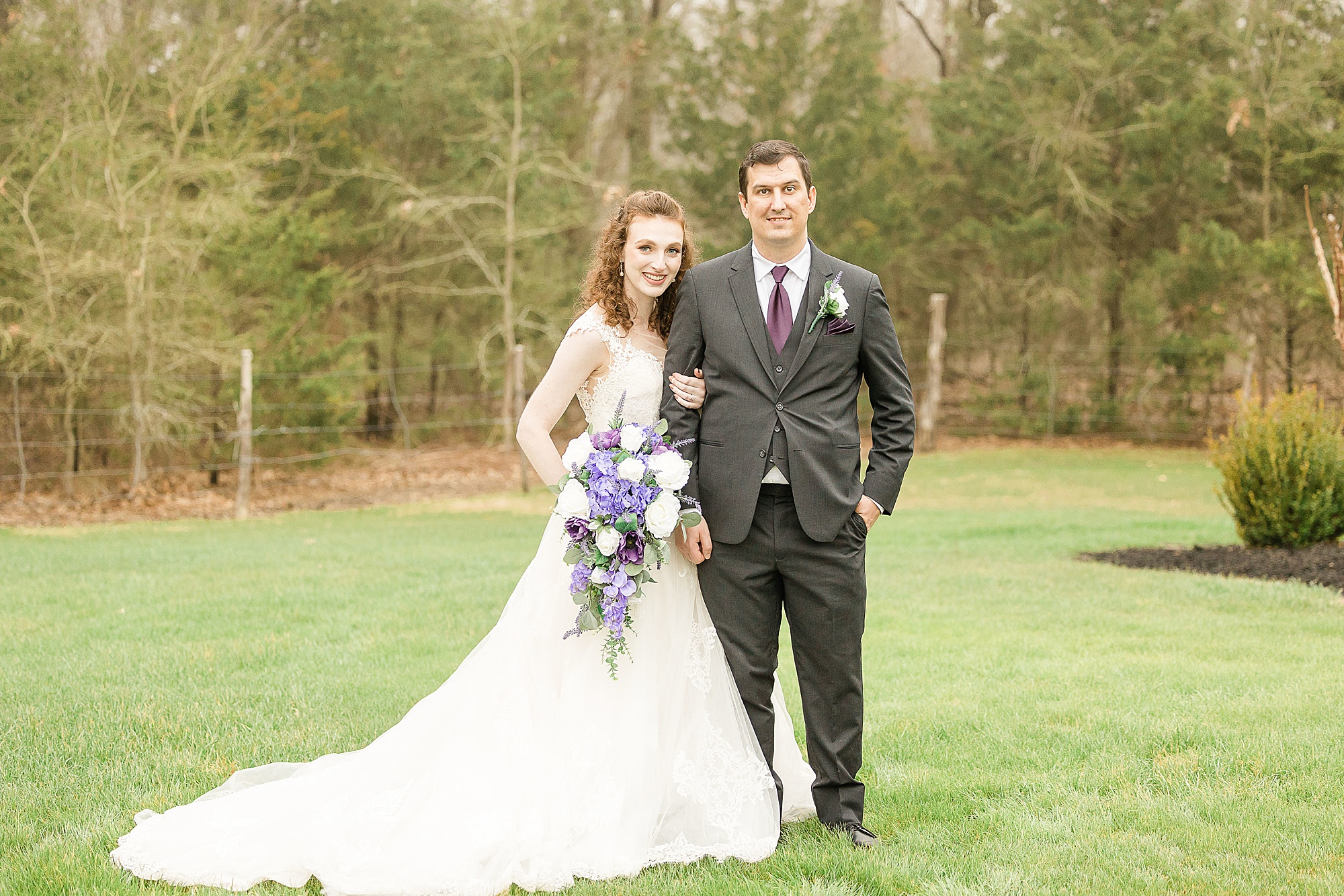 bride and groom stand in grass at Stone Hall at the Springs