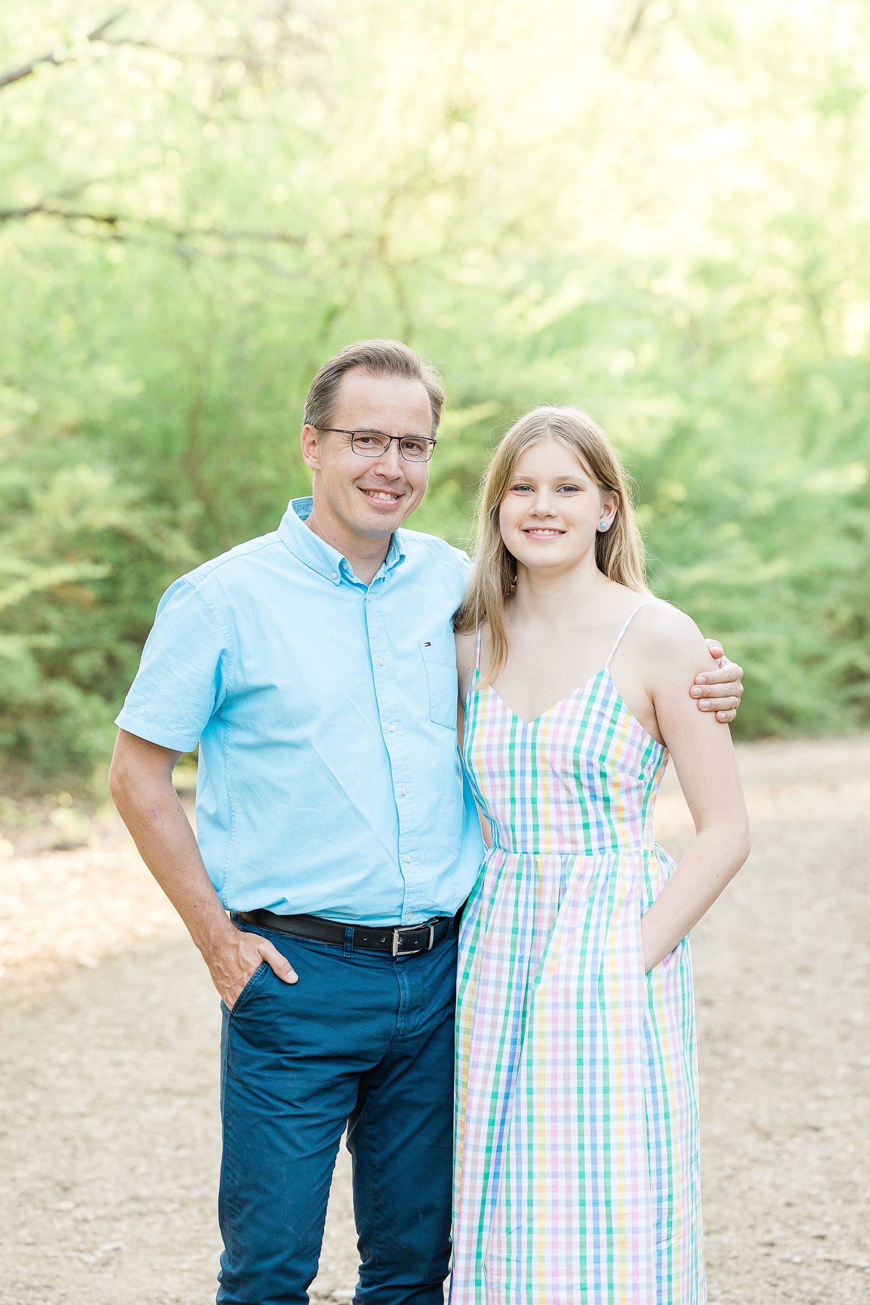 dad hugs teenage daughter during family photos at Clear Creek Natural Heritage Center